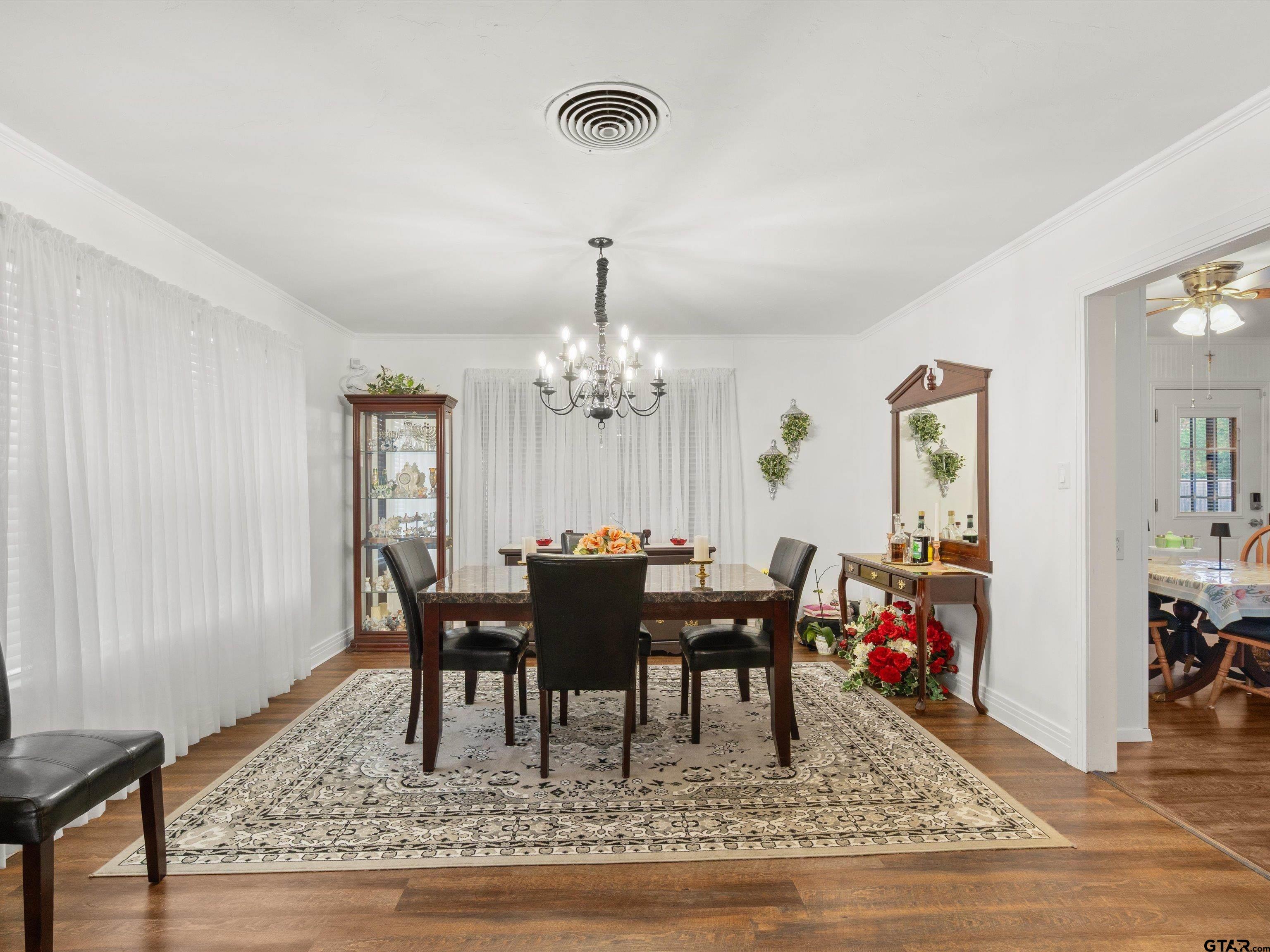 618 Walnut Street Gilmer, TX 75644 - Photo 14 of 30 a view of a dining room with furniture and chandelier