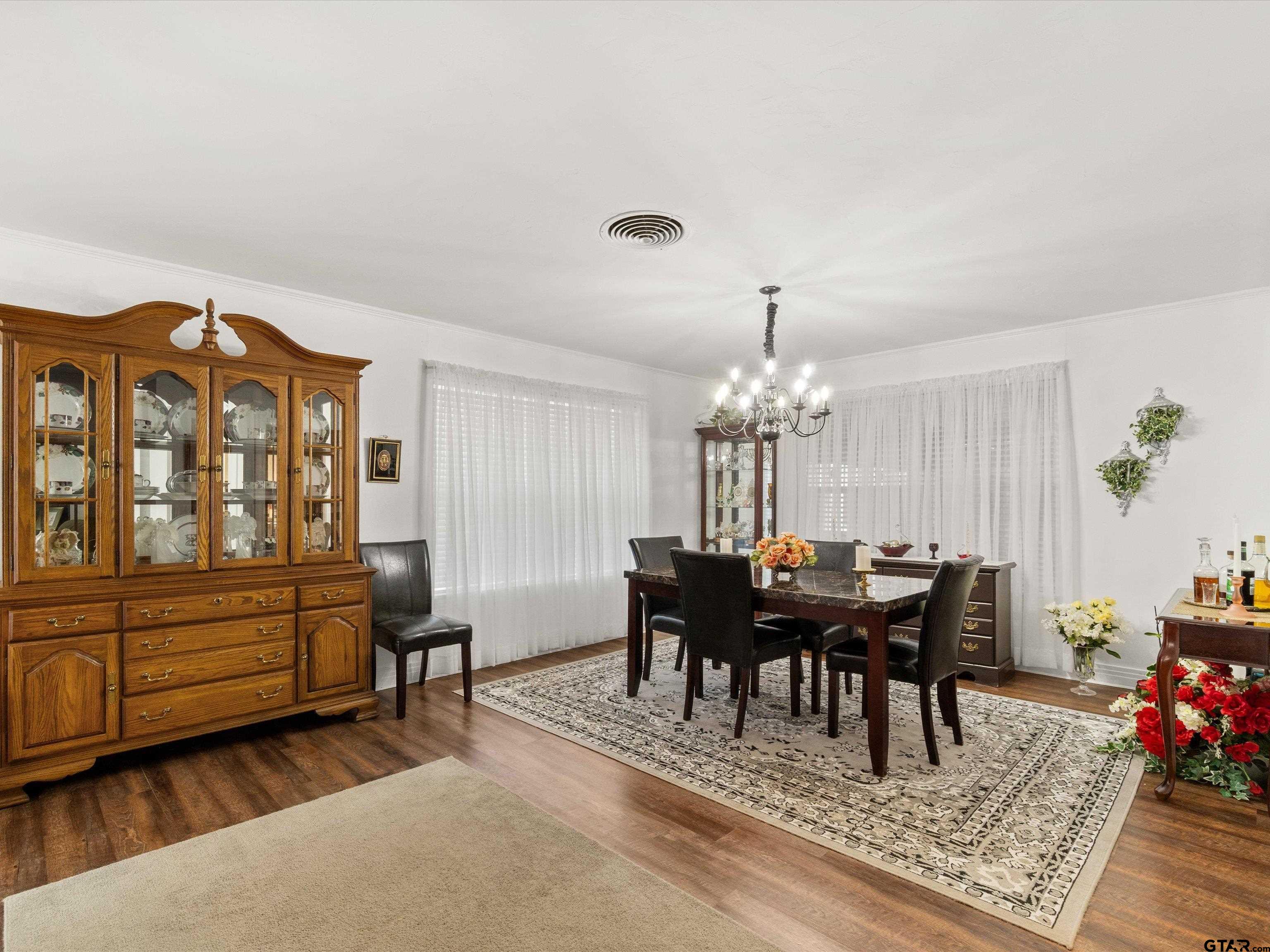 618 Walnut Street Gilmer, TX 75644 - Photo 15 of 30 a view of a dining room with furniture and chandelier