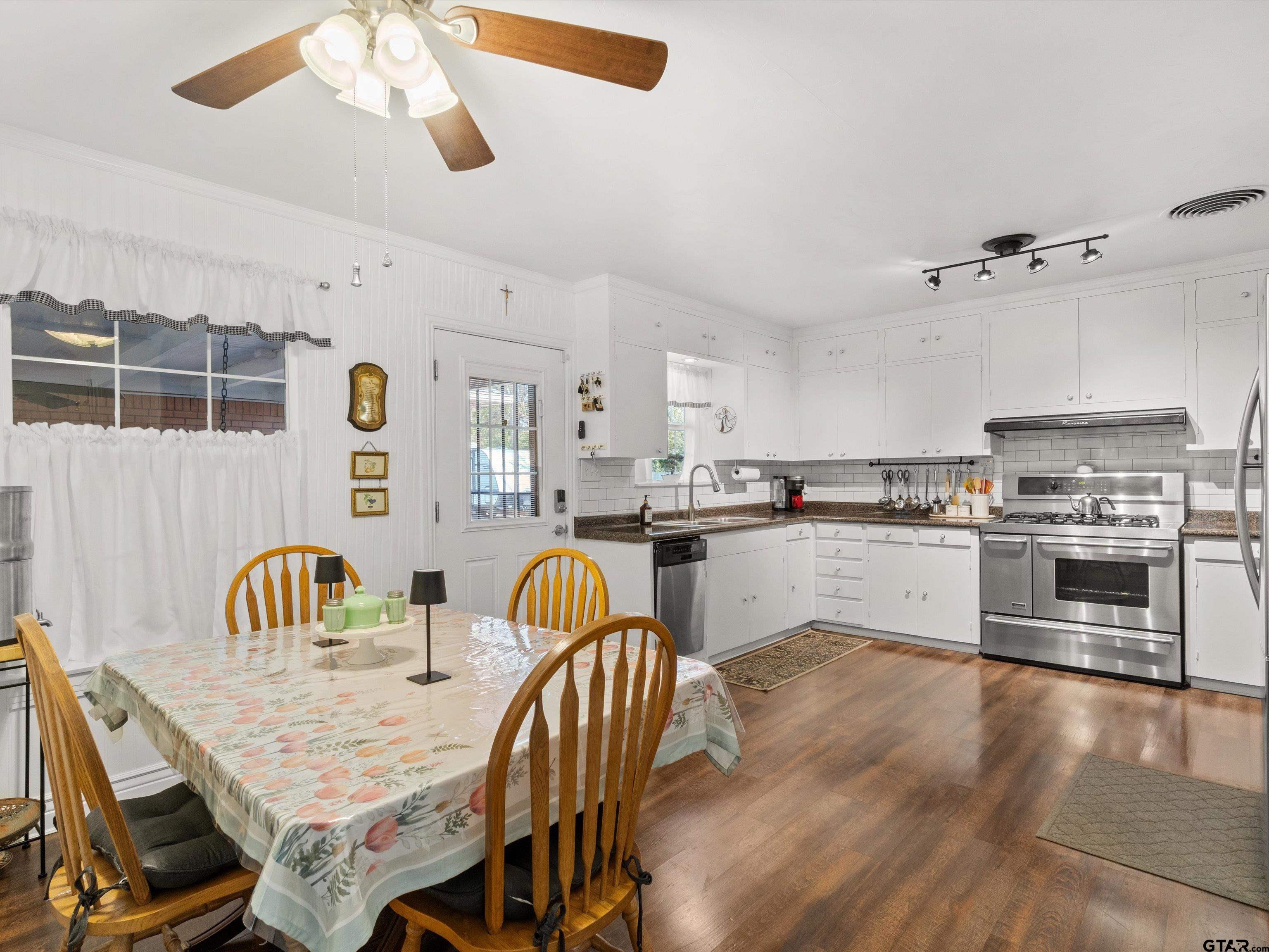 618 Walnut Street Gilmer, TX 75644 - Photo 16 of 30 a kitchen with a table chairs sink and cabinets