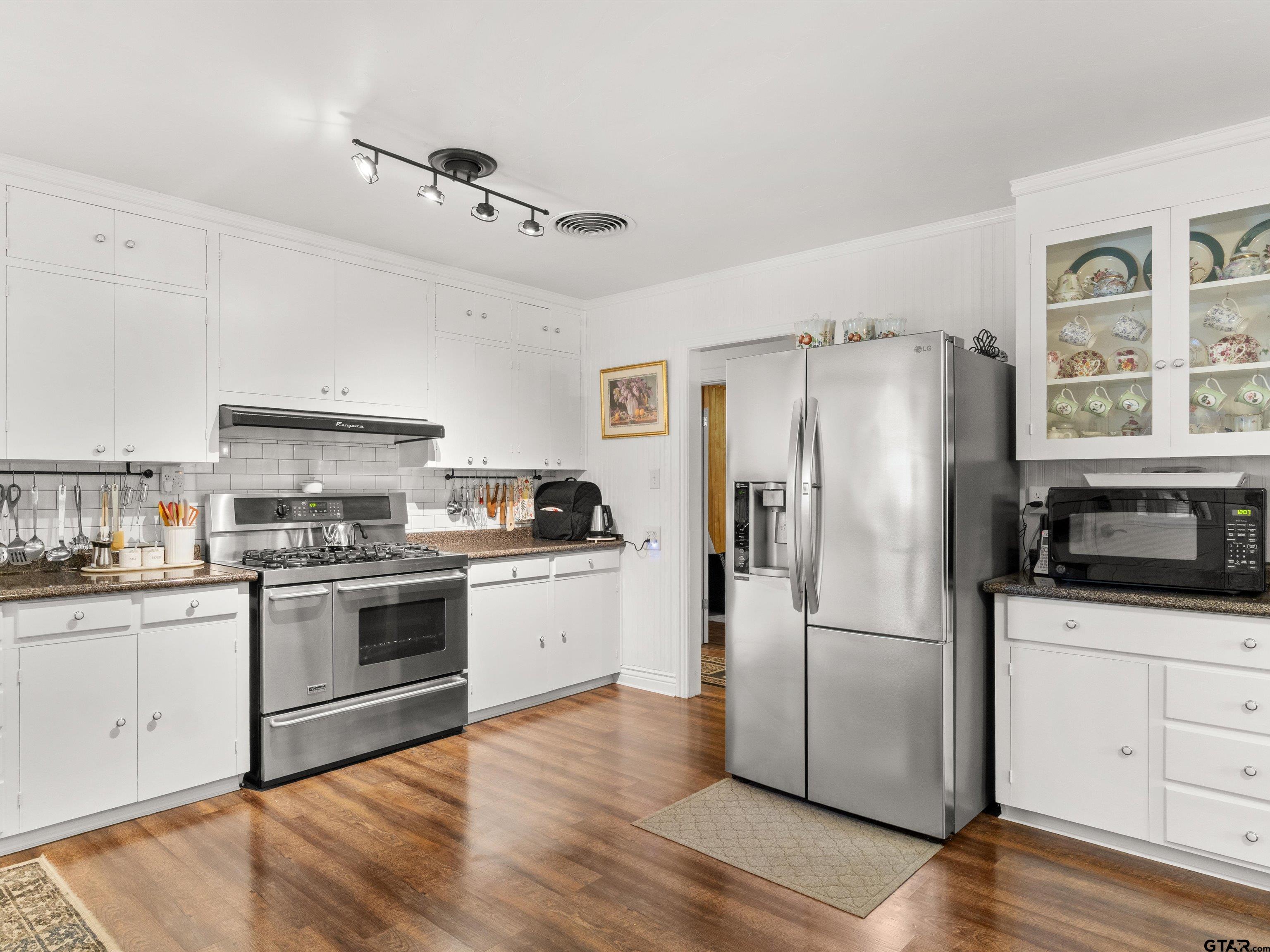 618 Walnut Street Gilmer, TX 75644 - Photo 18 of 30 a kitchen with granite countertop a refrigerator stove and sink
