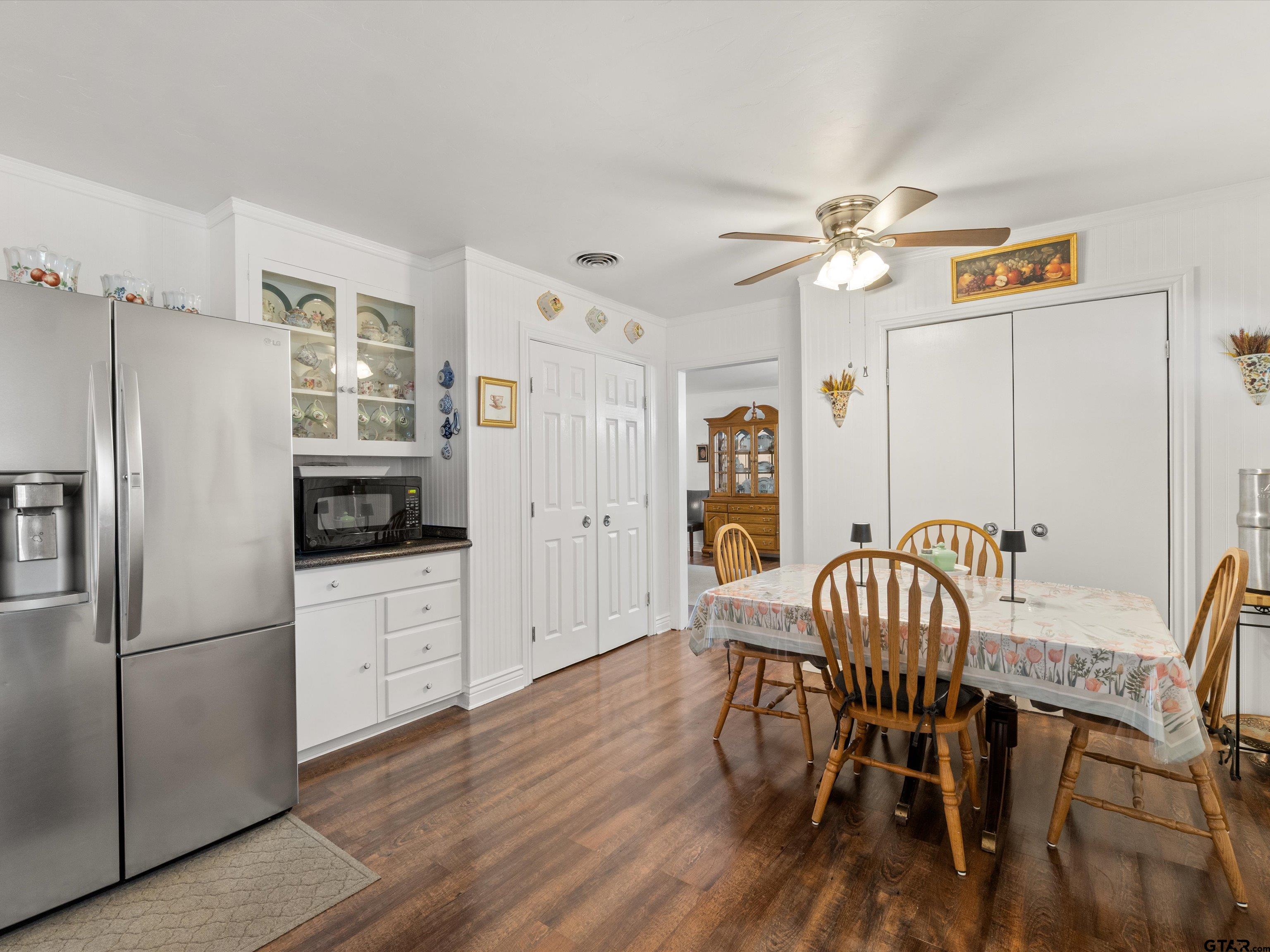 618 Walnut Street Gilmer, TX 75644 - Photo 20 of 30 a kitchen with stainless steel appliances granite countertop a dining table chairs refrigerator and sink