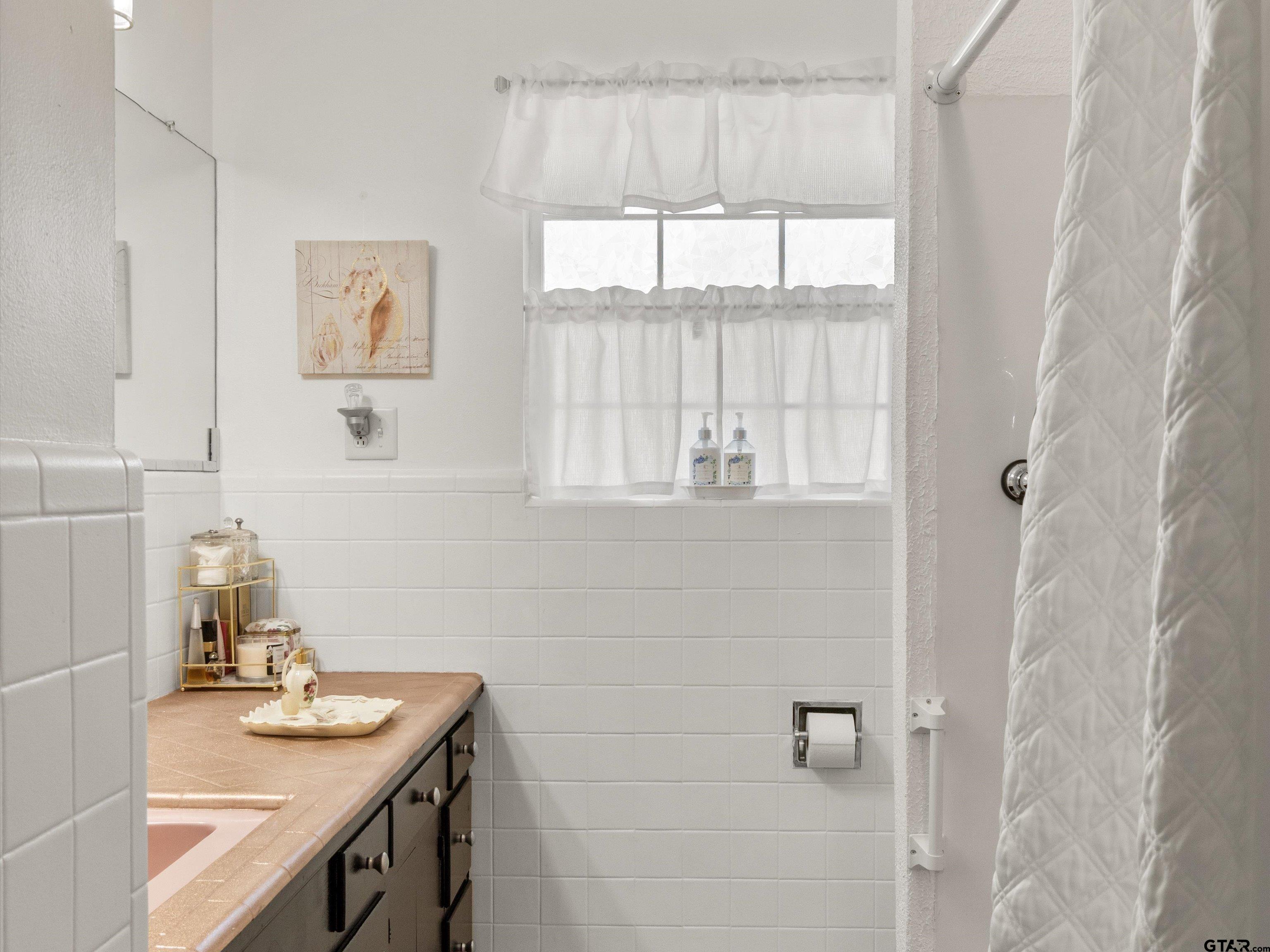 618 Walnut Street Gilmer, TX 75644 - Photo 22 of 30 a bathroom with a sink and a window