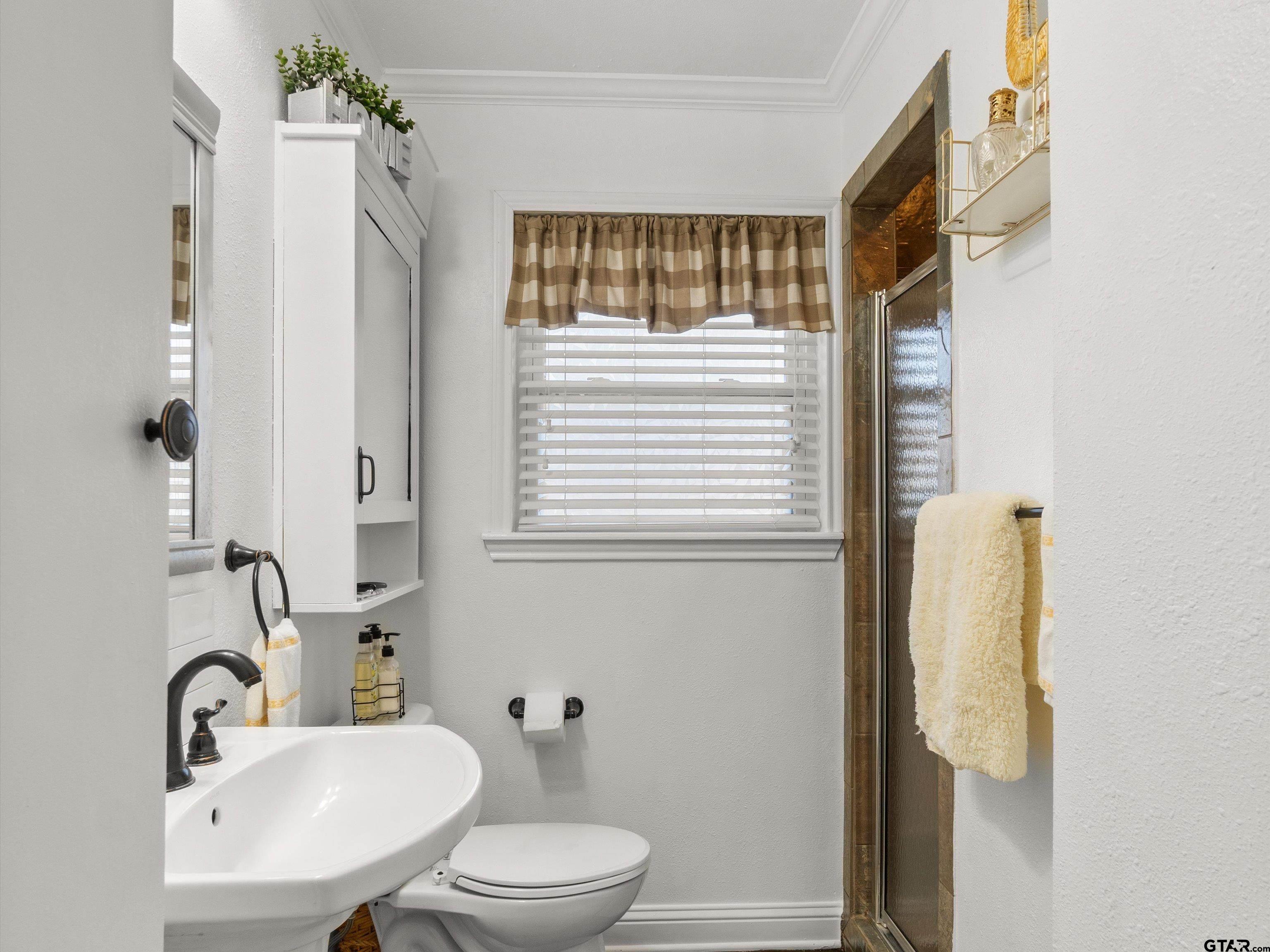 618 Walnut Street Gilmer, TX 75644 - Photo 24 of 30 a bathroom with a sink a toilet and shower