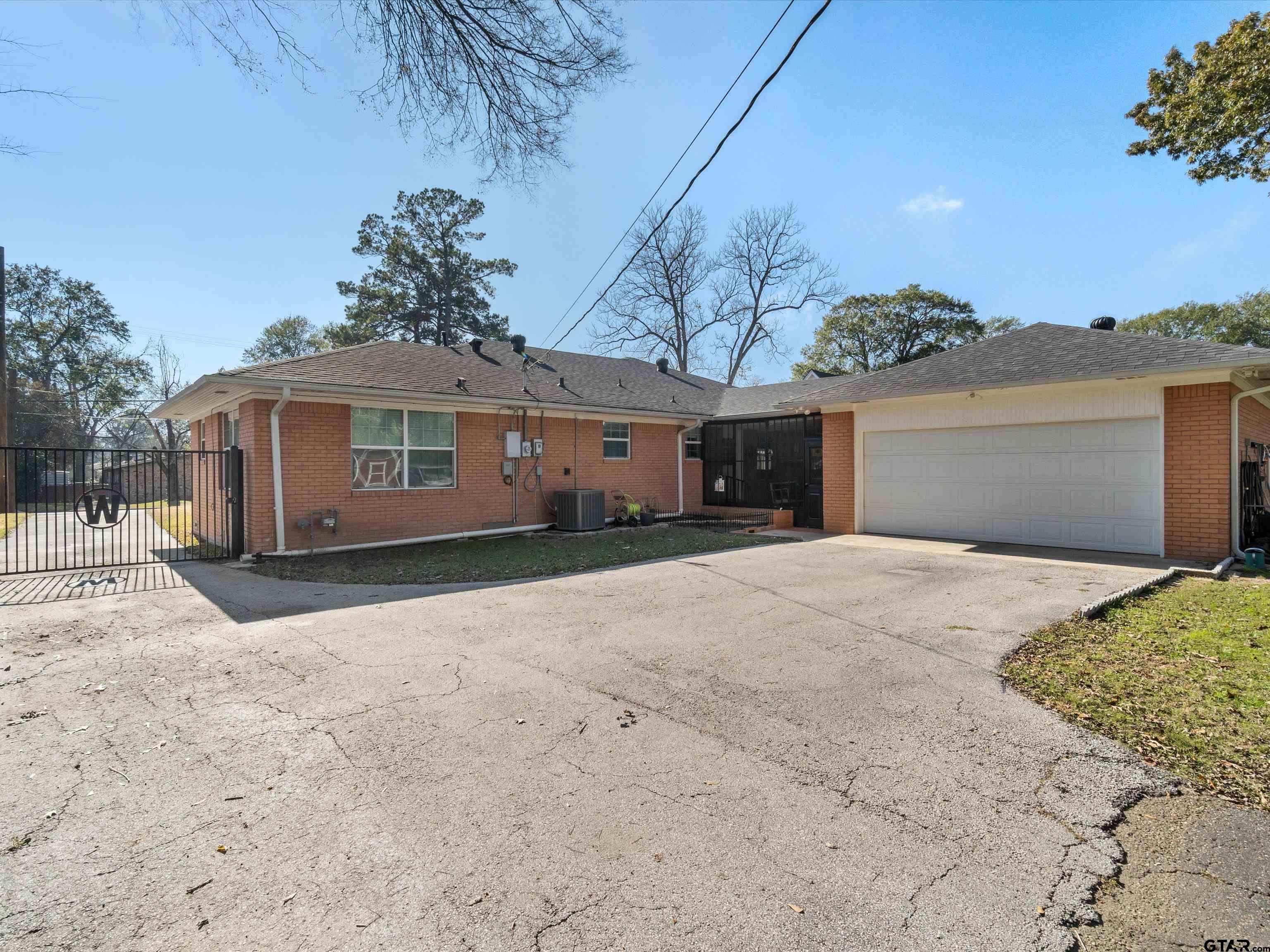 618 Walnut Street Gilmer, TX 75644 - Photo 29 of 30 a front view of a house with a yard and garage