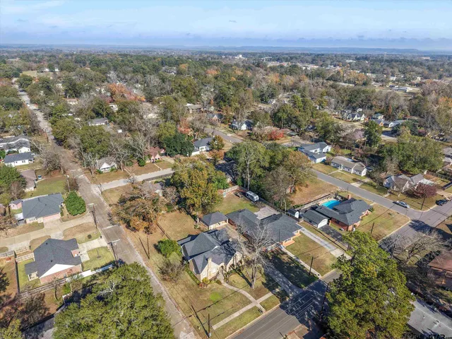 an aerial view of residential building with green space