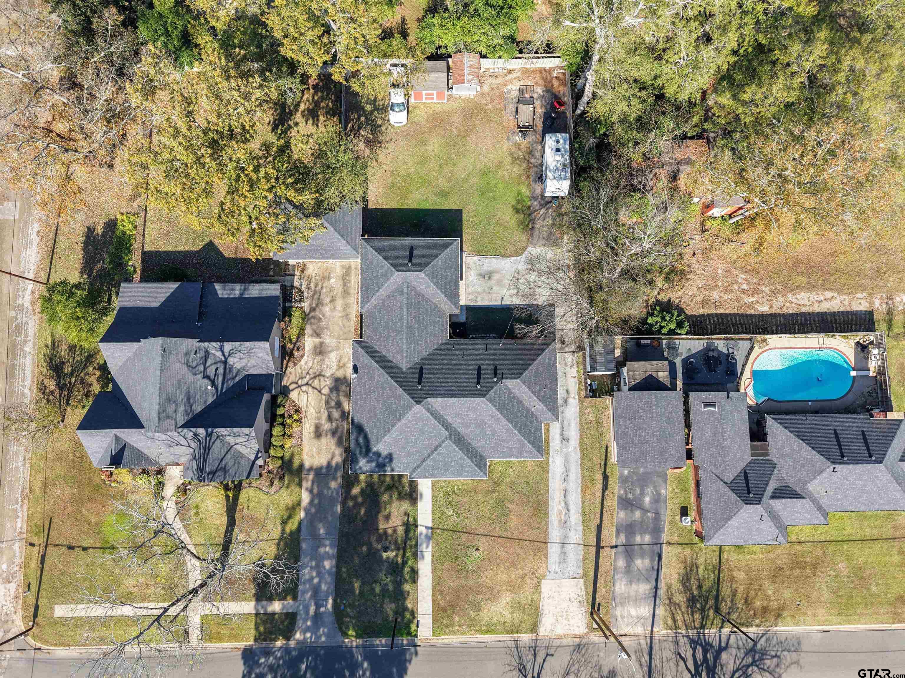618 Walnut Street Gilmer, TX 75644 - Photo 5 of 30 an aerial view of a house with swimming pool and large trees