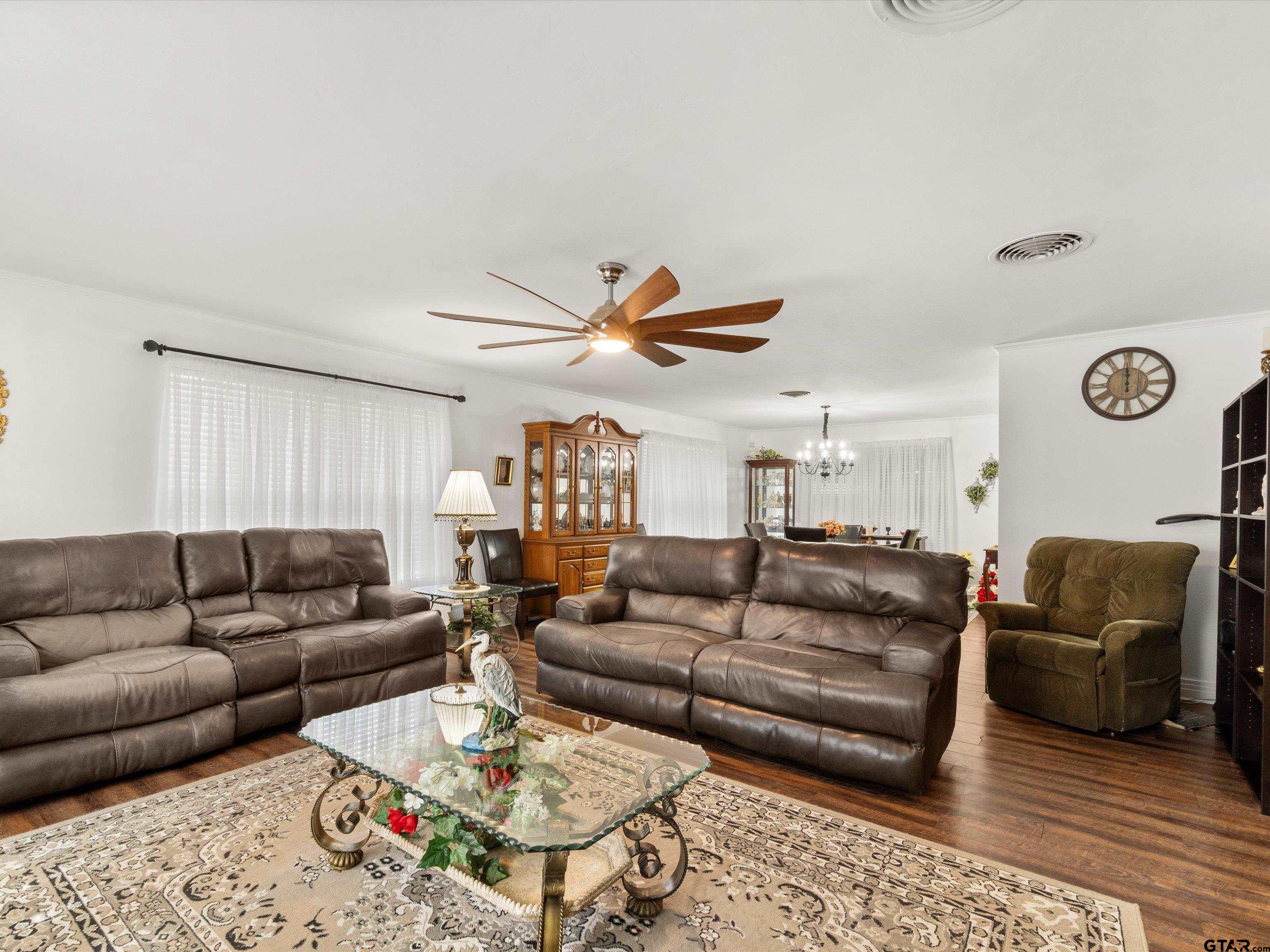 618 Walnut Street Gilmer, TX 75644 - Photo 9 of 30 a living room with furniture ceiling fan and a rug