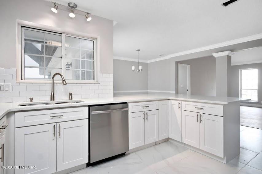 4283 Heath Road Jacksonville, FL 32277 - Photo 13 of 30 a kitchen with white cabinets and sink