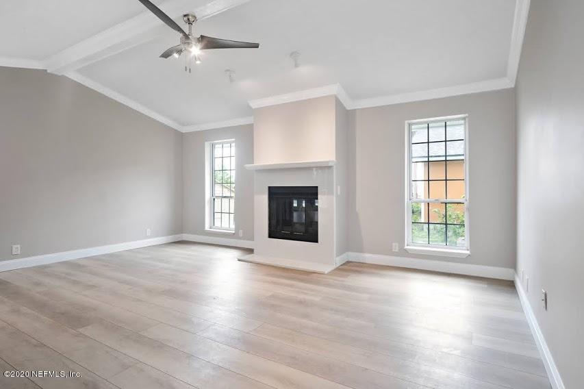 4283 Heath Road Jacksonville, FL 32277 - Photo 16 of 30 an empty room with wooden floor fireplace and windows