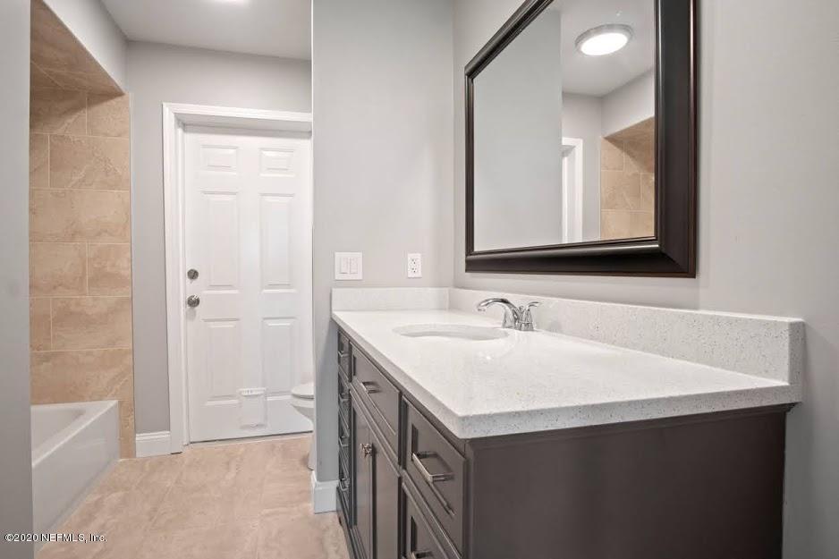 4283 Heath Road Jacksonville, FL 32277 - Photo 20 of 30 a bathroom with a sink and a mirror