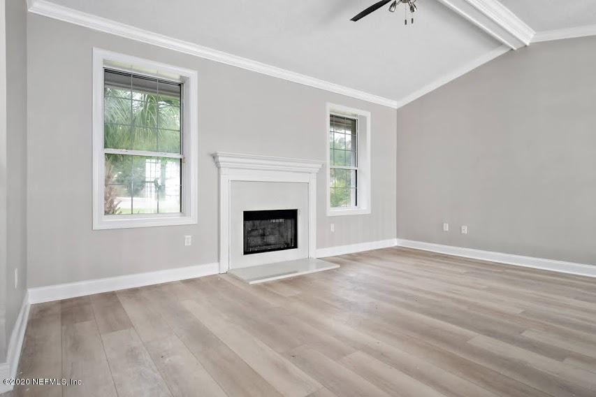 4283 Heath Road Jacksonville, FL 32277 - Photo 6 of 30 an empty room with windows and fireplace