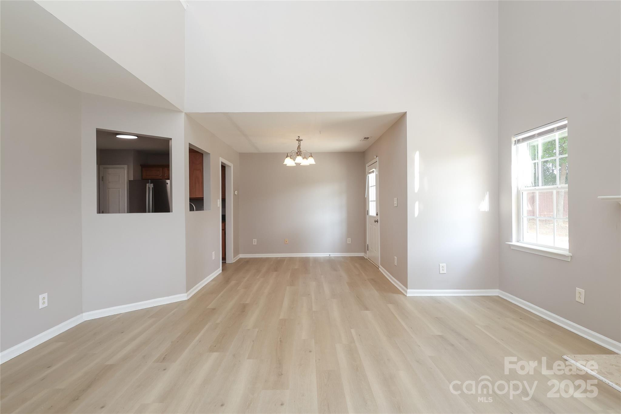 4112 Chatterleigh Drive Monroe, NC 28110 - Photo 11 of 43 a view of an empty room with wooden floor and windows