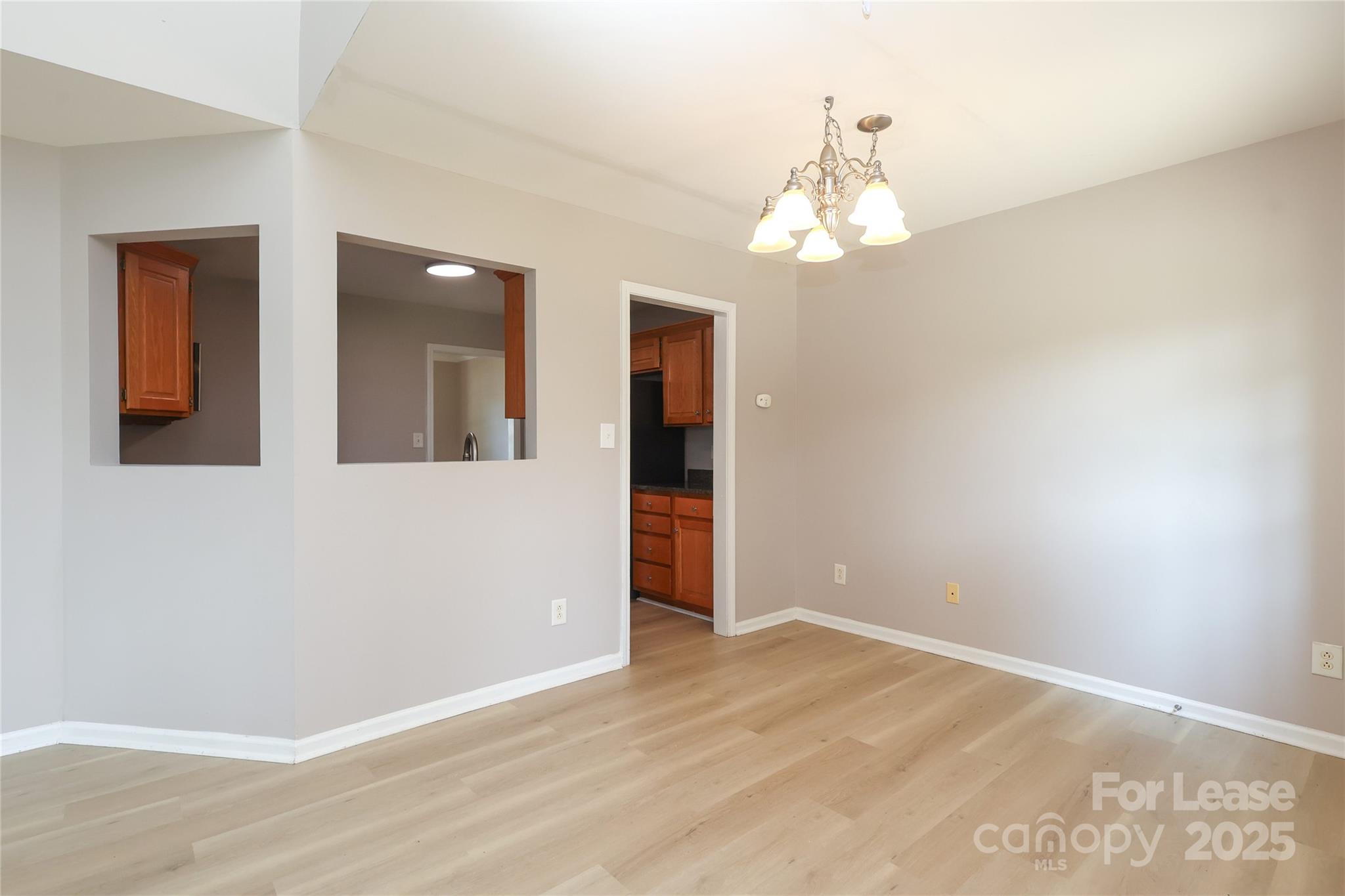 4112 Chatterleigh Drive Monroe, NC 28110 - Photo 12 of 43 wooden floor in an empty room with a window