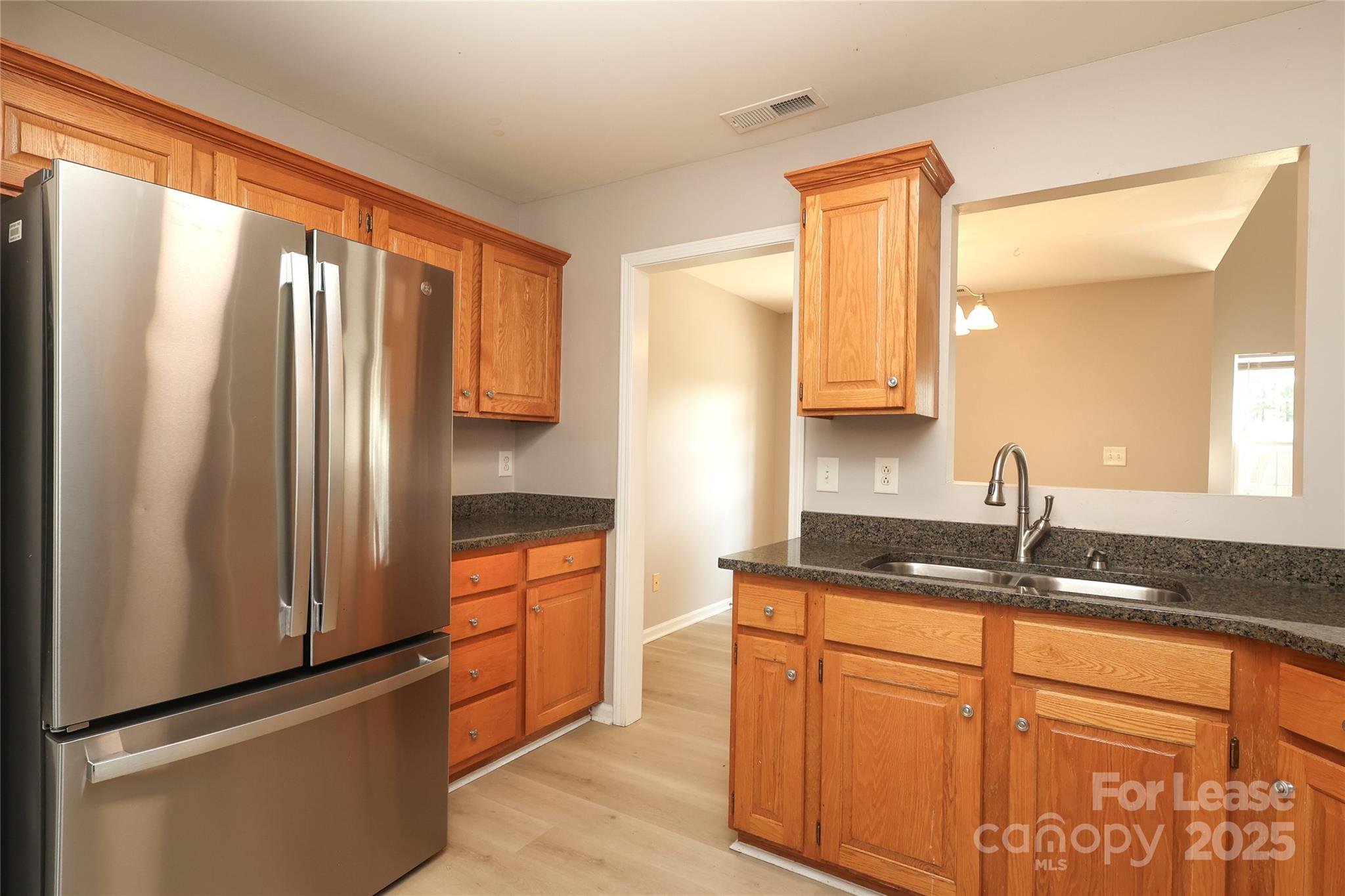 4112 Chatterleigh Drive Monroe, NC 28110 - Photo 16 of 43 a kitchen with stainless steel appliances granite countertop a refrigerator and a sink