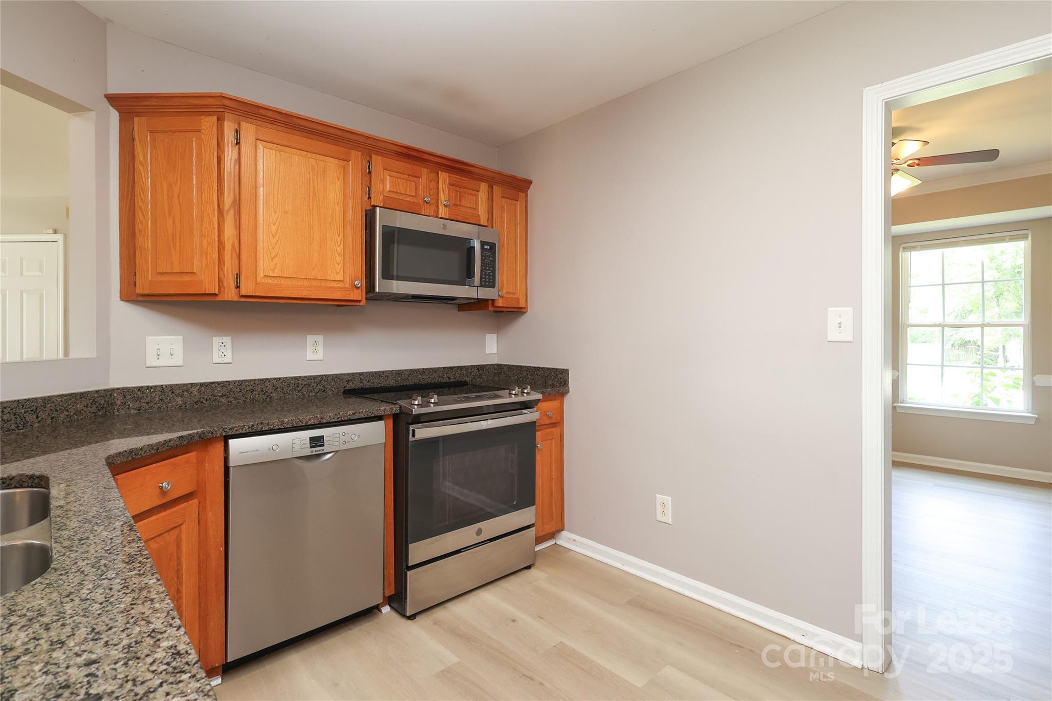 4112 Chatterleigh Drive Monroe, NC 28110 - Photo 17 of 43 a kitchen with stainless steel appliances granite countertop a stove microwave and sink
