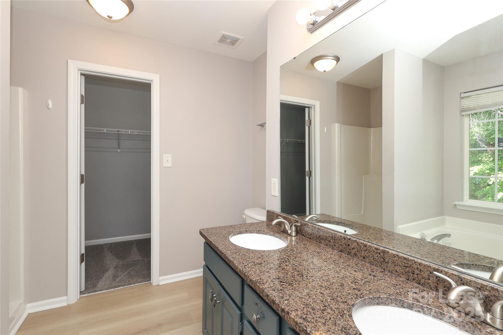4112 Chatterleigh Drive Monroe, NC 28110 - Photo 25 of 43 a bathroom with a granite countertop sink and a mirror