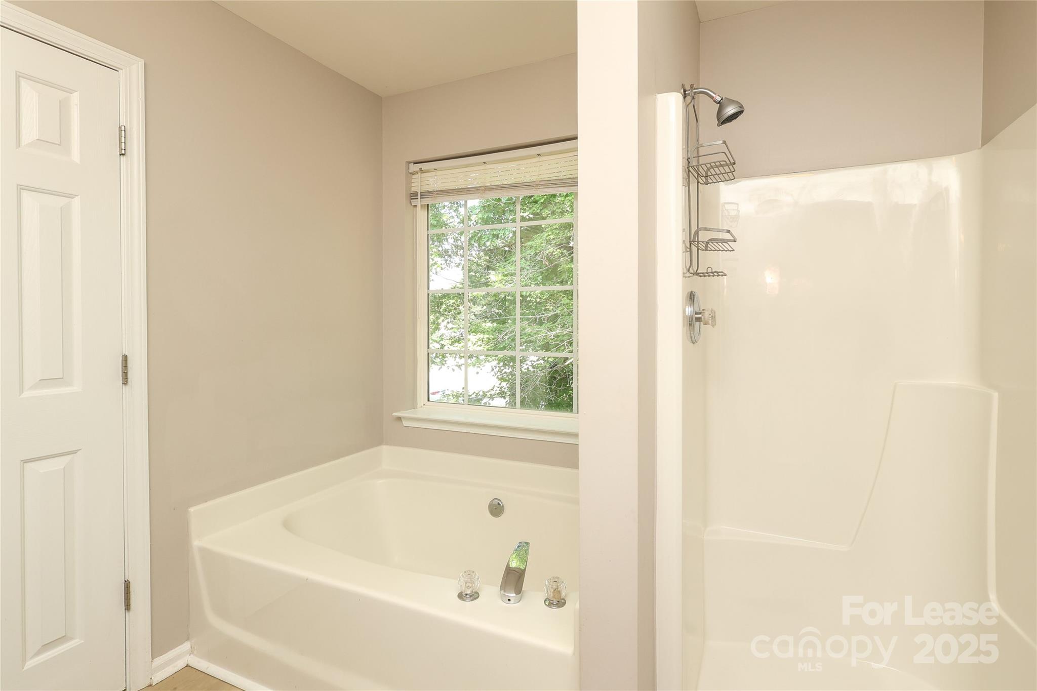 4112 Chatterleigh Drive Monroe, NC 28110 - Photo 28 of 43 a white bath tub sitting next to a window