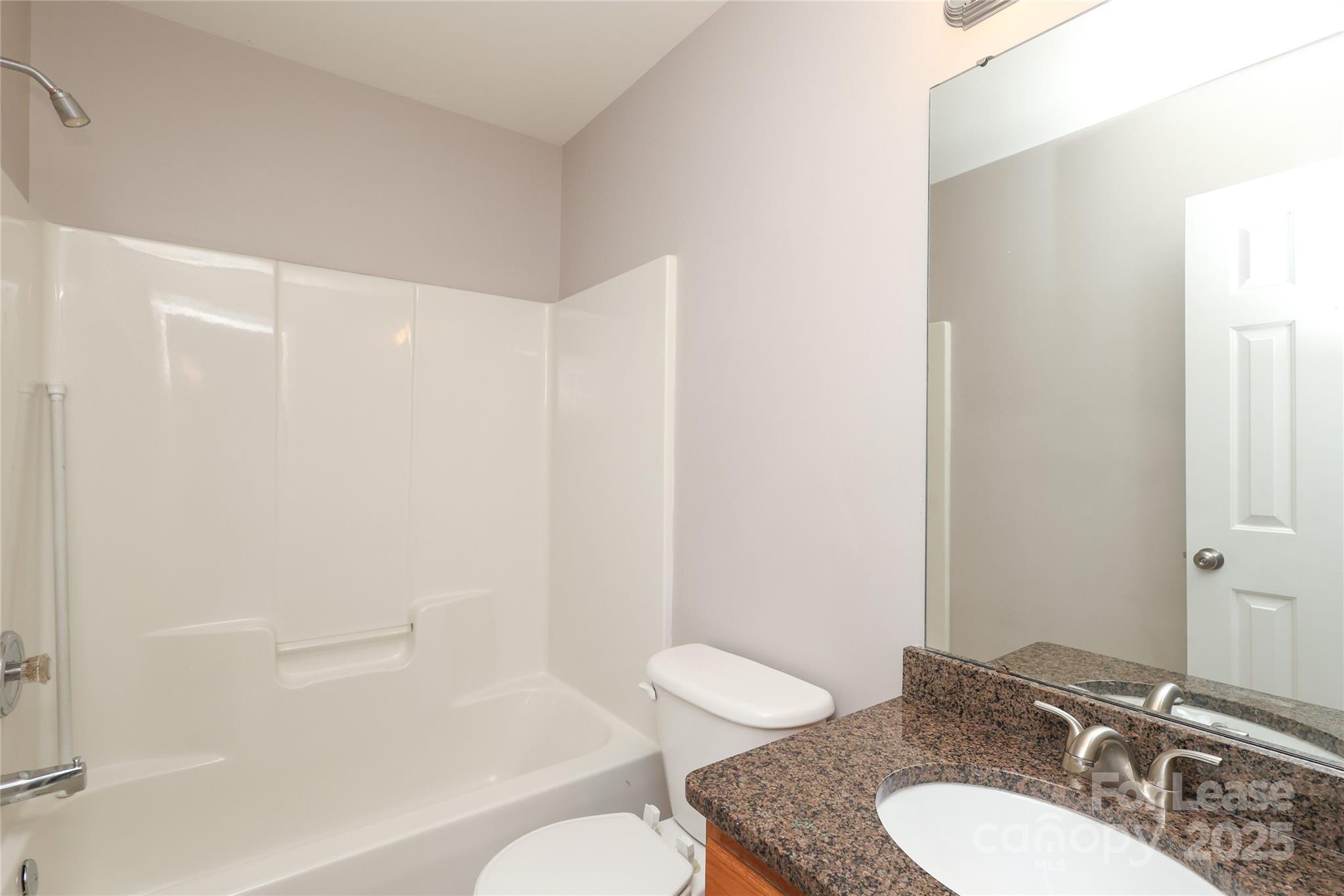 4112 Chatterleigh Drive Monroe, NC 28110 - Photo 36 of 43 a bathroom with a granite countertop sink toilet a mirror and shower