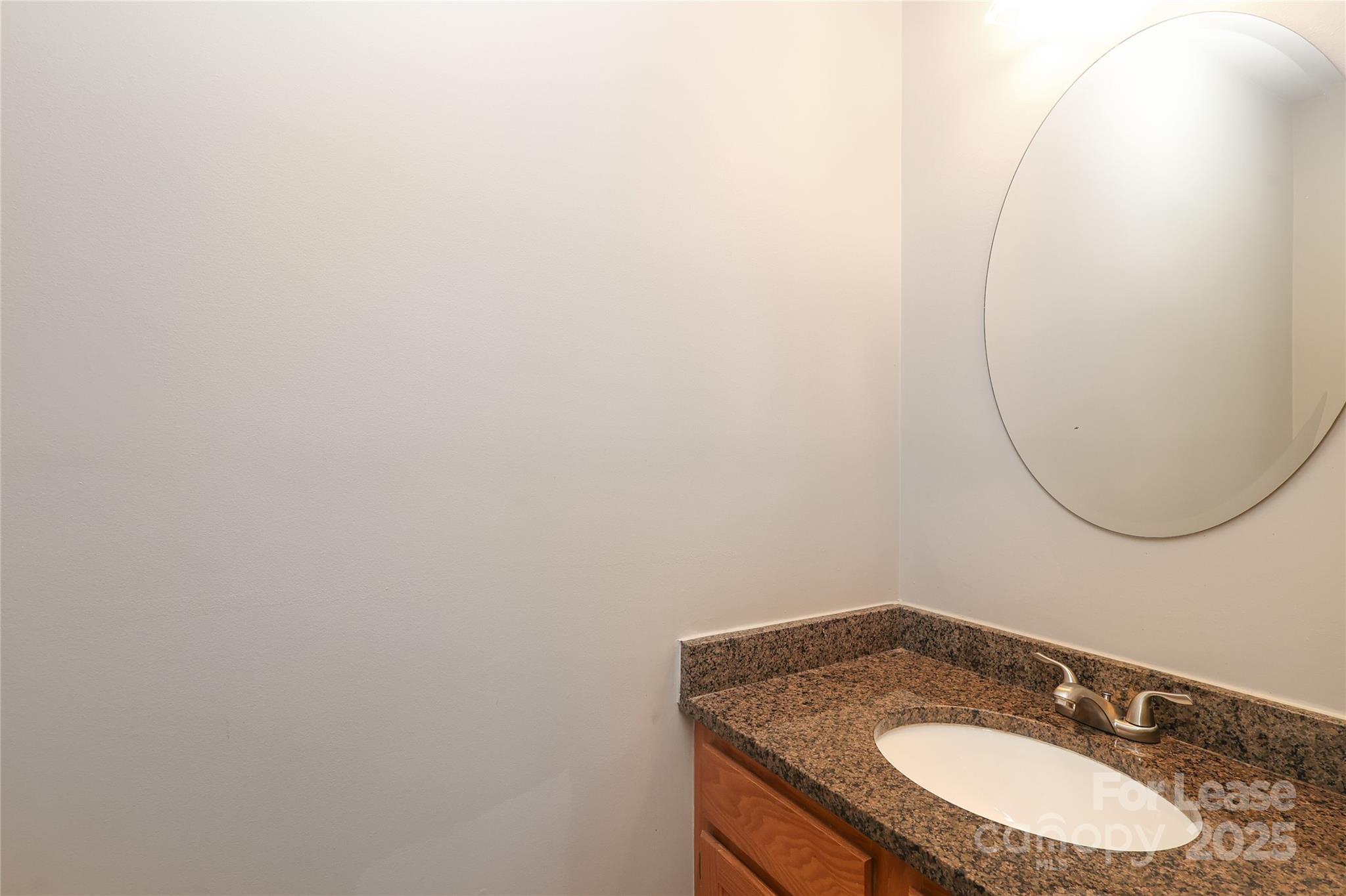 4112 Chatterleigh Drive Monroe, NC 28110 - Photo 8 of 43 a bathroom with a granite countertop sink and a mirror
