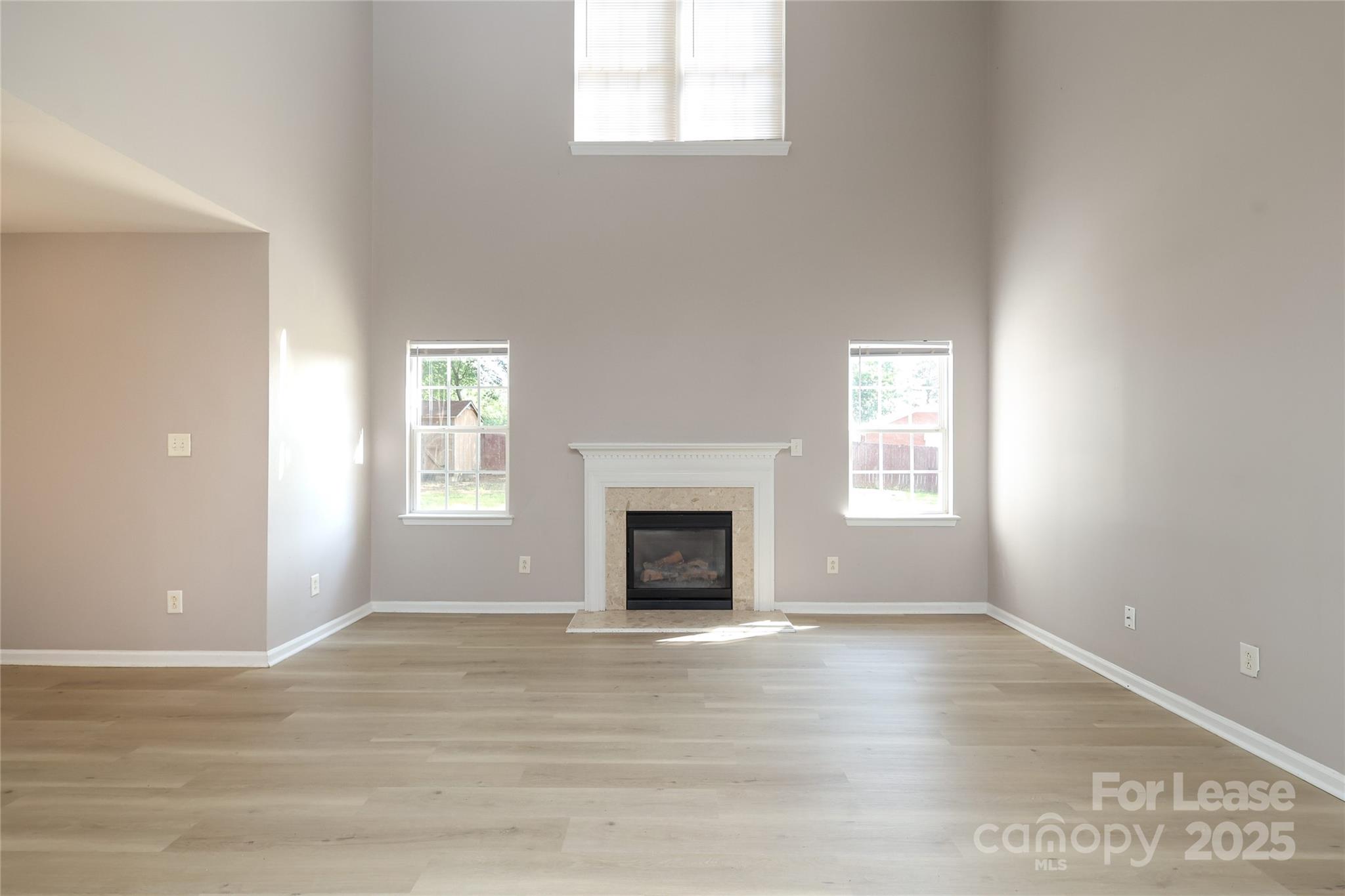 4112 Chatterleigh Drive Monroe, NC 28110 - Photo 9 of 43 wooden floor fireplace and windows in an empty room
