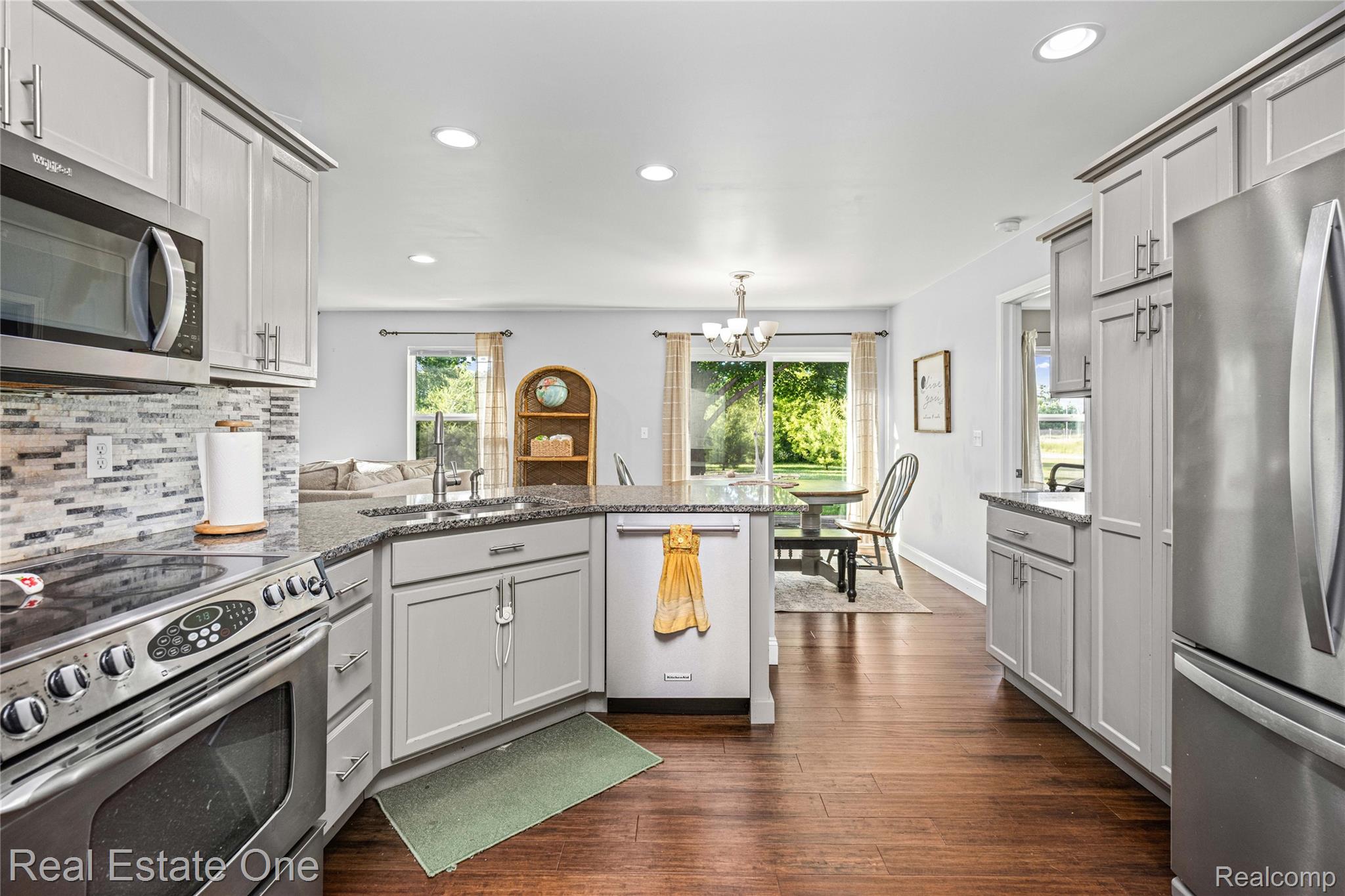 2479 Gibson Road Grand Blanc, MI 48439 - Photo 25 of 55 Kitchen featuring light gray cabinetry, stainless steel appliances, and dark granite countertops