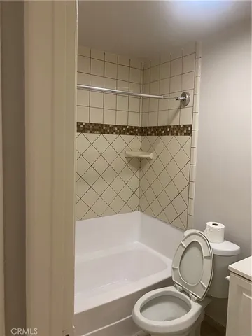 a bathroom with a toilet and a bathtub