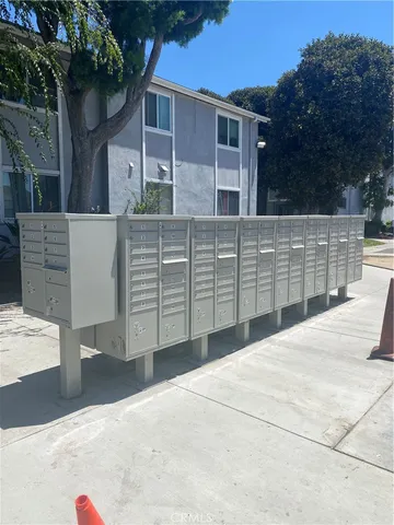 a view of backyard with barbeque grill and wooden fence