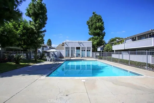 a view of swimming pool with a lounge chairs
