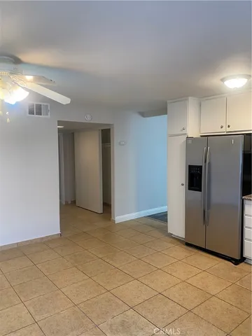 a view of a kitchen with refrigerator and cabinets