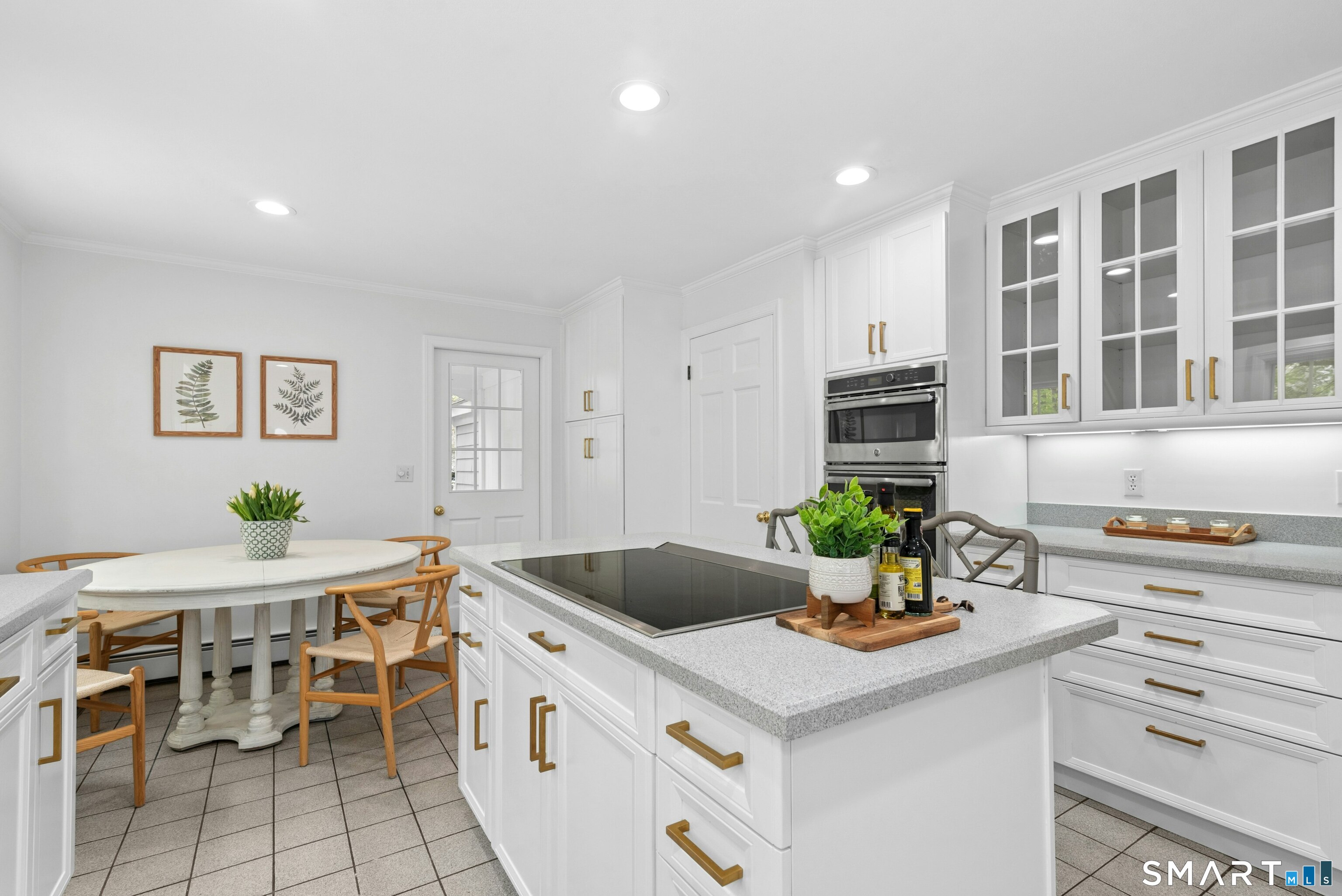 254 White Oak Shade Road New Canaan, CT 06840 - Photo 16 of 31 a kitchen with a stove a table and chairs