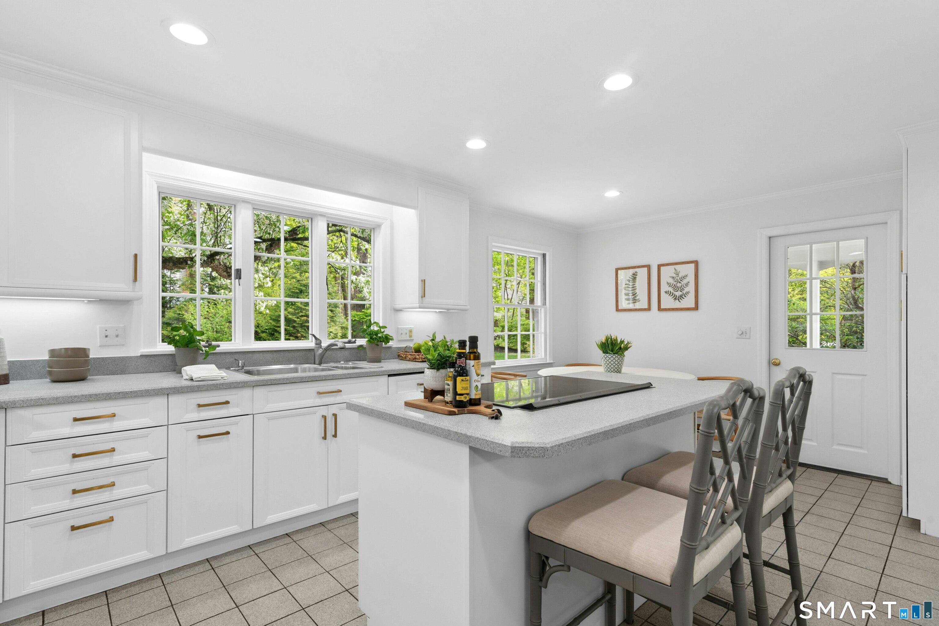 254 White Oak Shade Road New Canaan, CT 06840 - Photo 18 of 31 a kitchen with a table chairs and white appliances