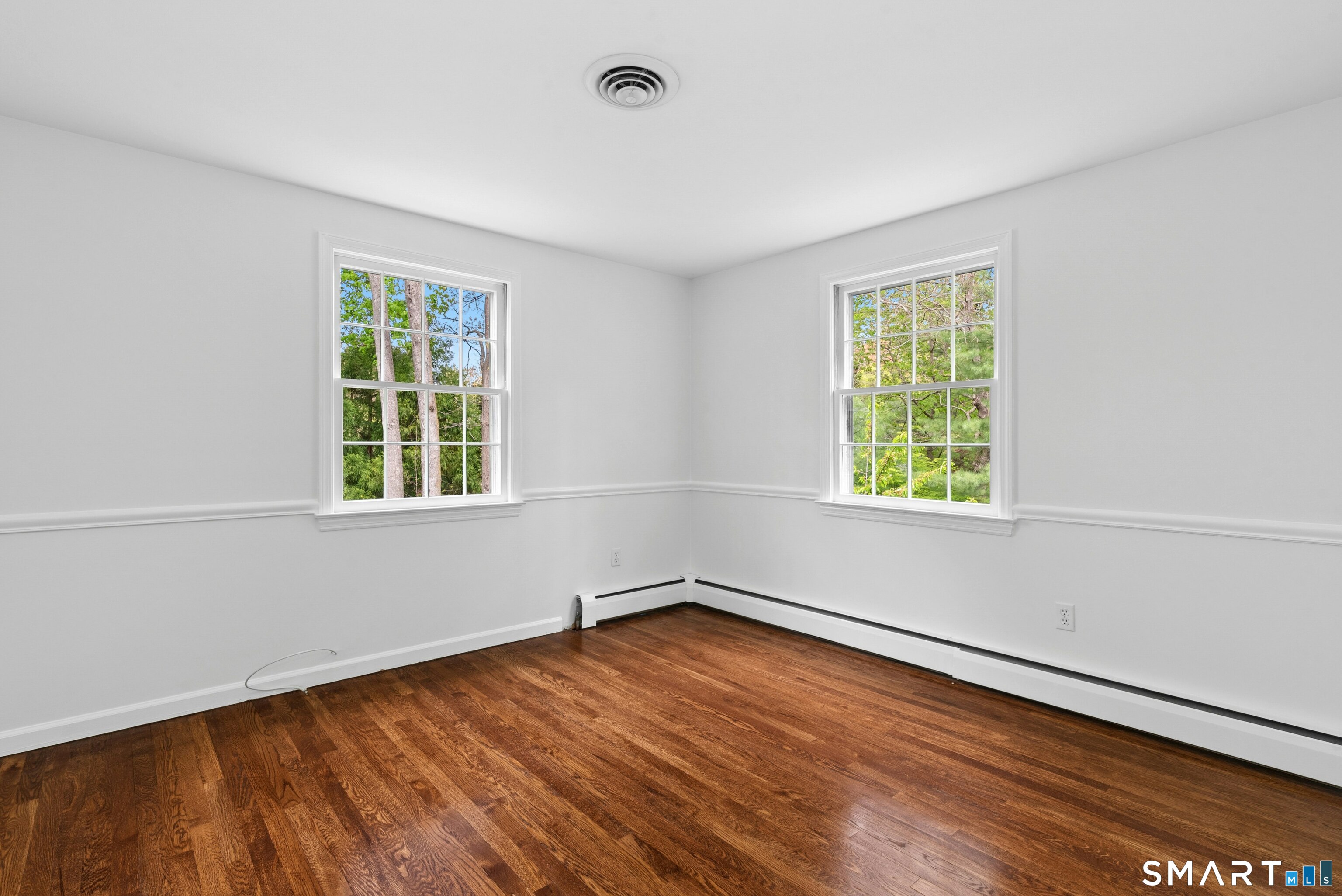 254 White Oak Shade Road New Canaan, CT 06840 - Photo 21 of 31 an empty room with wooden floor and windows