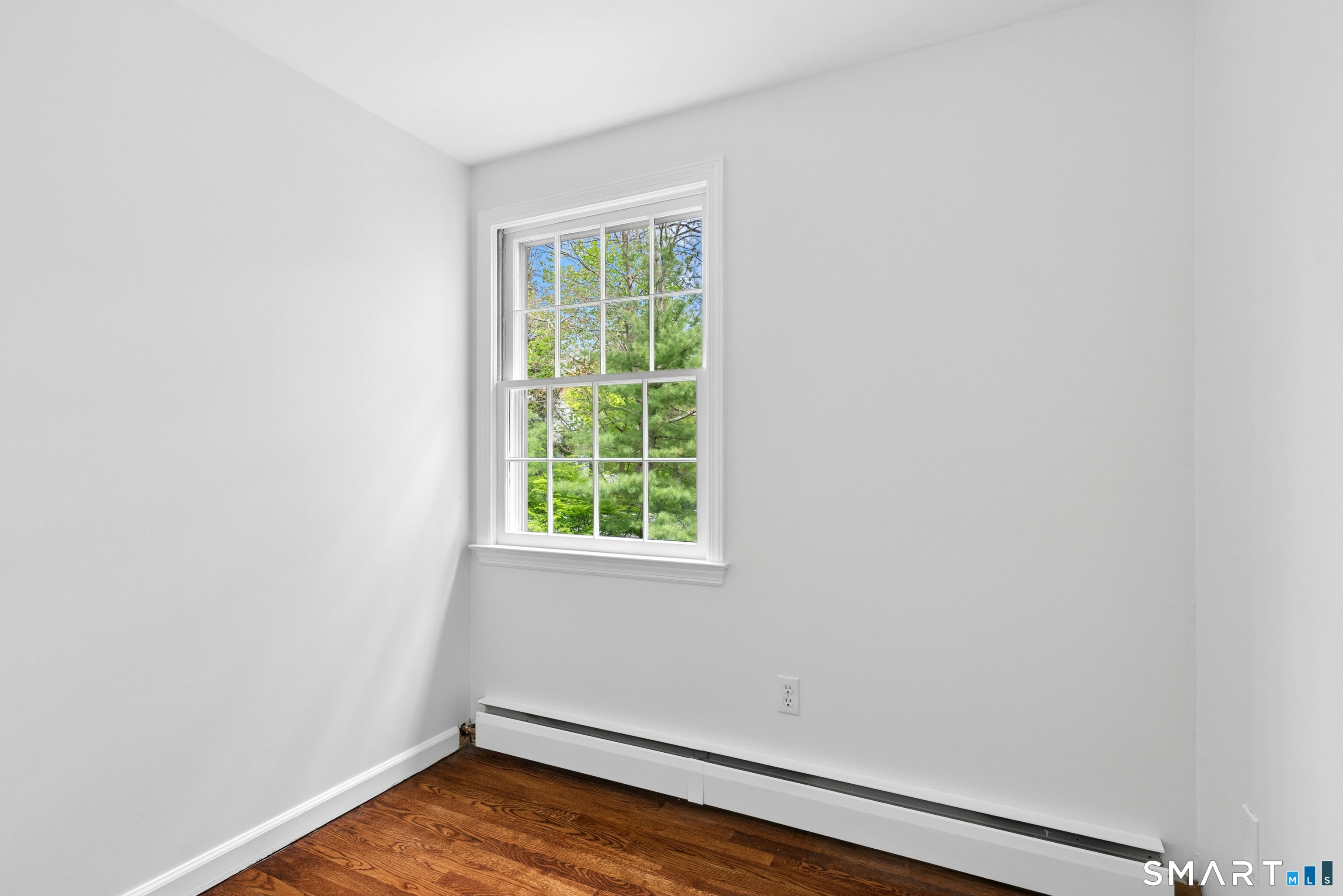 254 White Oak Shade Road New Canaan, CT 06840 - Photo 26 of 31 an empty room with wooden floor and windows