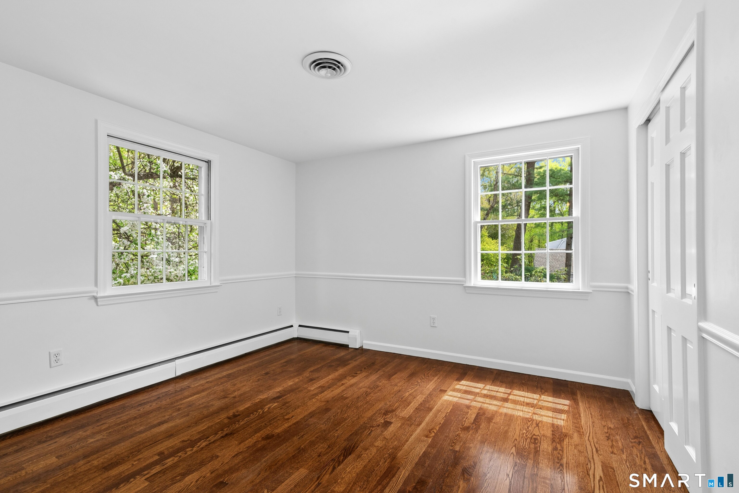 254 White Oak Shade Road New Canaan, CT 06840 - Photo 27 of 31 wooden floor in an empty room with a window