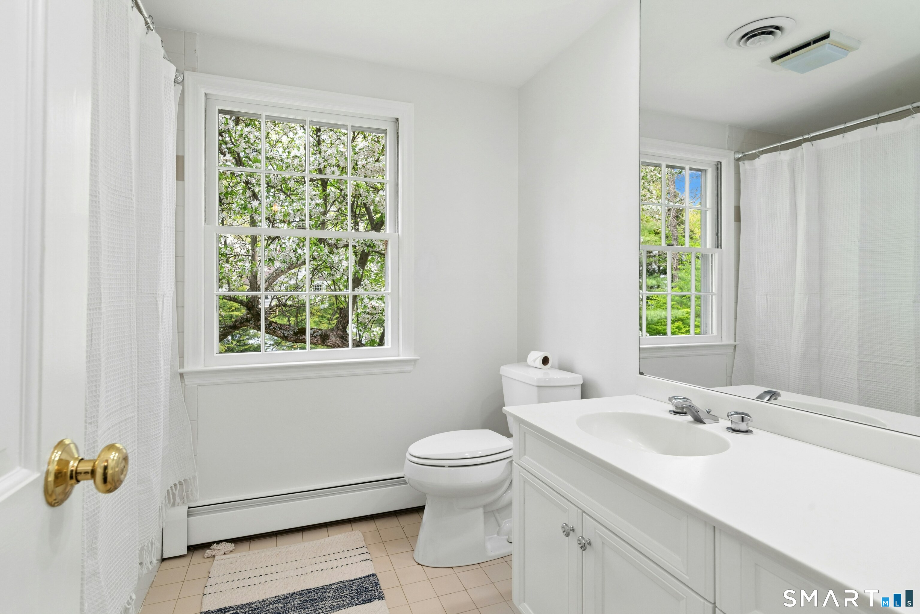254 White Oak Shade Road New Canaan, CT 06840 - Photo 28 of 31 a bathroom with a double vanity sink toilet and a mirror