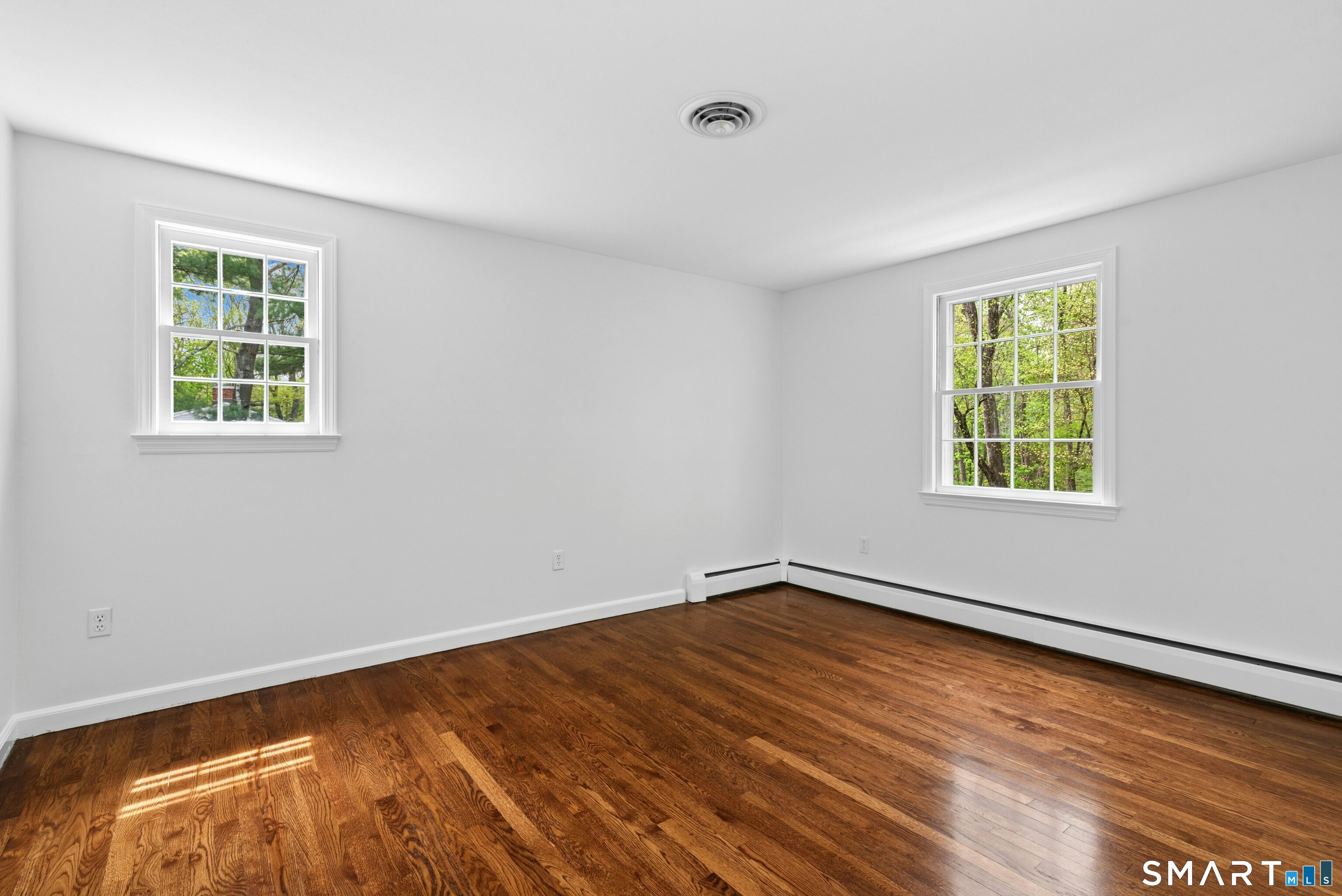 254 White Oak Shade Road New Canaan, CT 06840 - Photo 29 of 31 a view of an empty room with wooden floor and a window