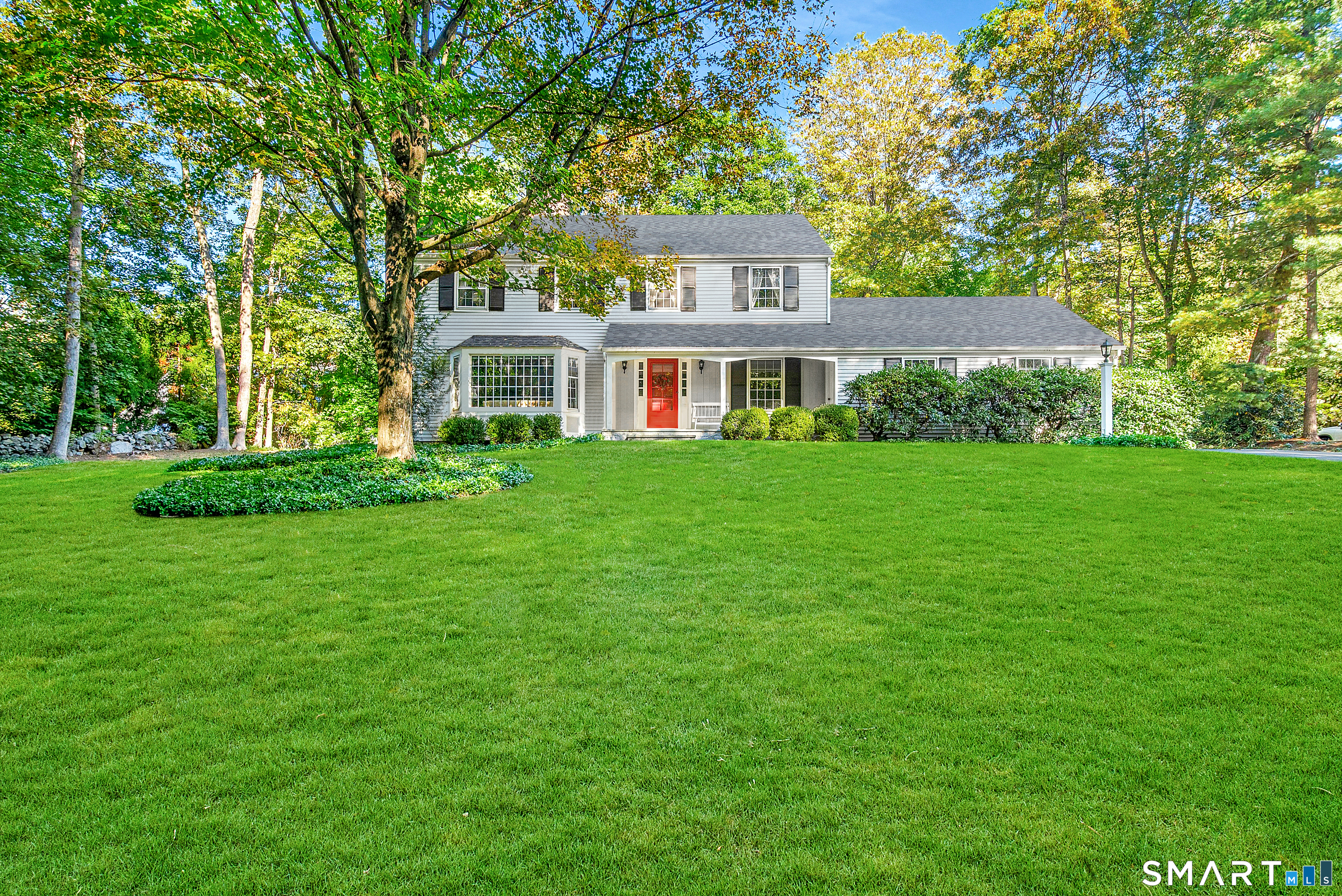 254 White Oak Shade Road New Canaan, CT 06840 - Photo 4 of 31 a front view of a house with a garden