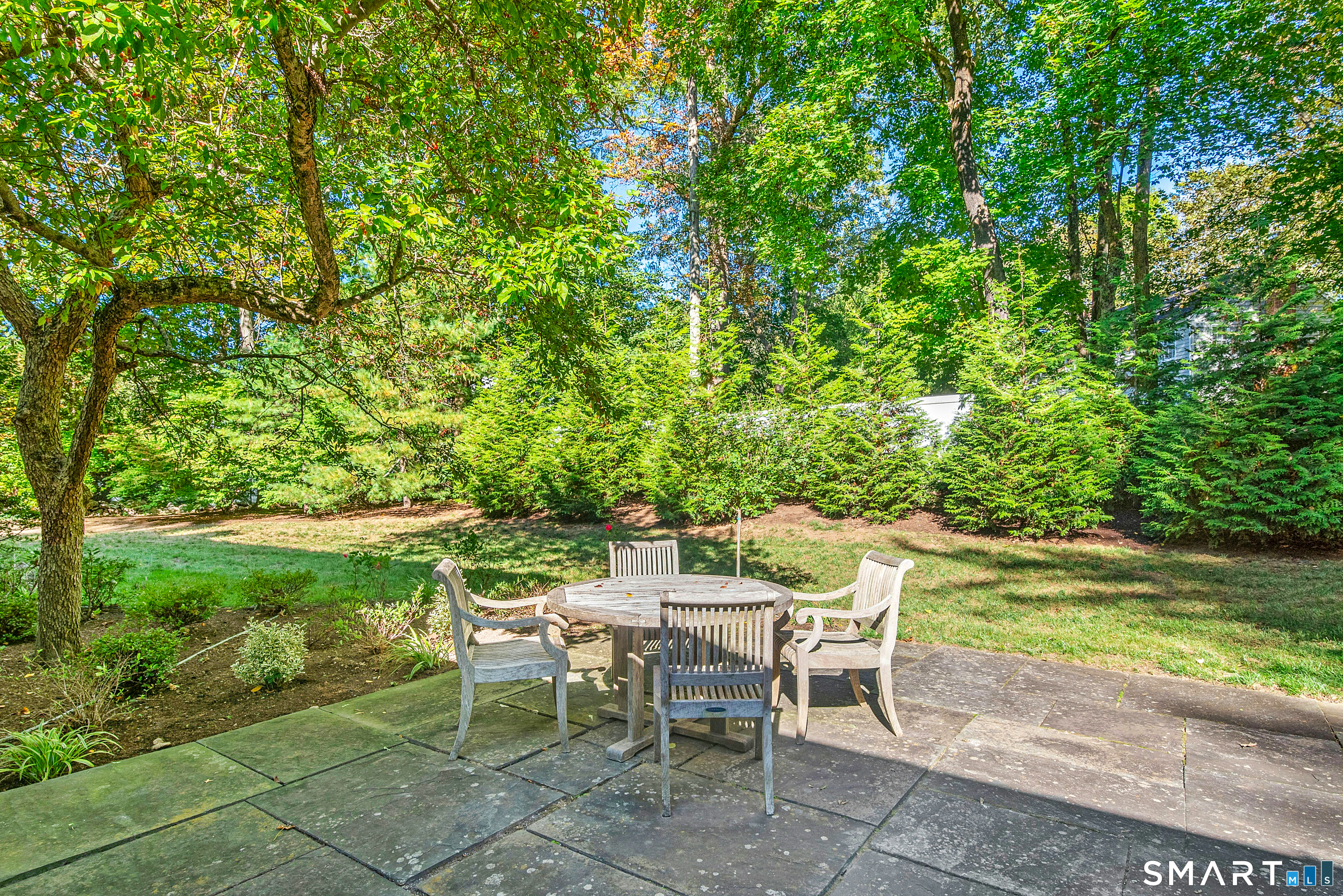 254 White Oak Shade Road New Canaan, CT 06840 - Photo 6 of 31 a view of a chairs and table in the garden