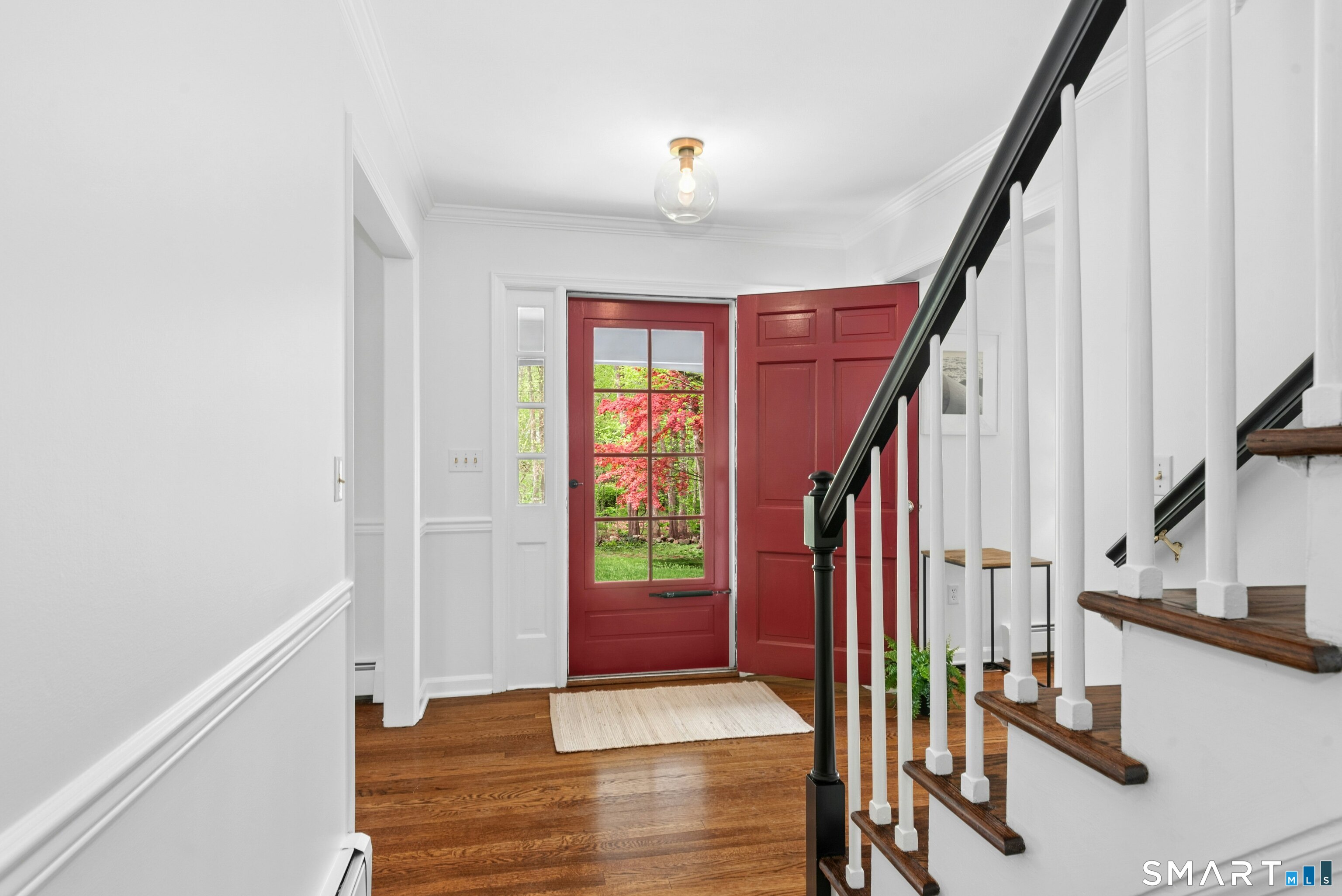 254 White Oak Shade Road New Canaan, CT 06840 - Photo 8 of 31 a view of an entryway with wooden floor and stairs