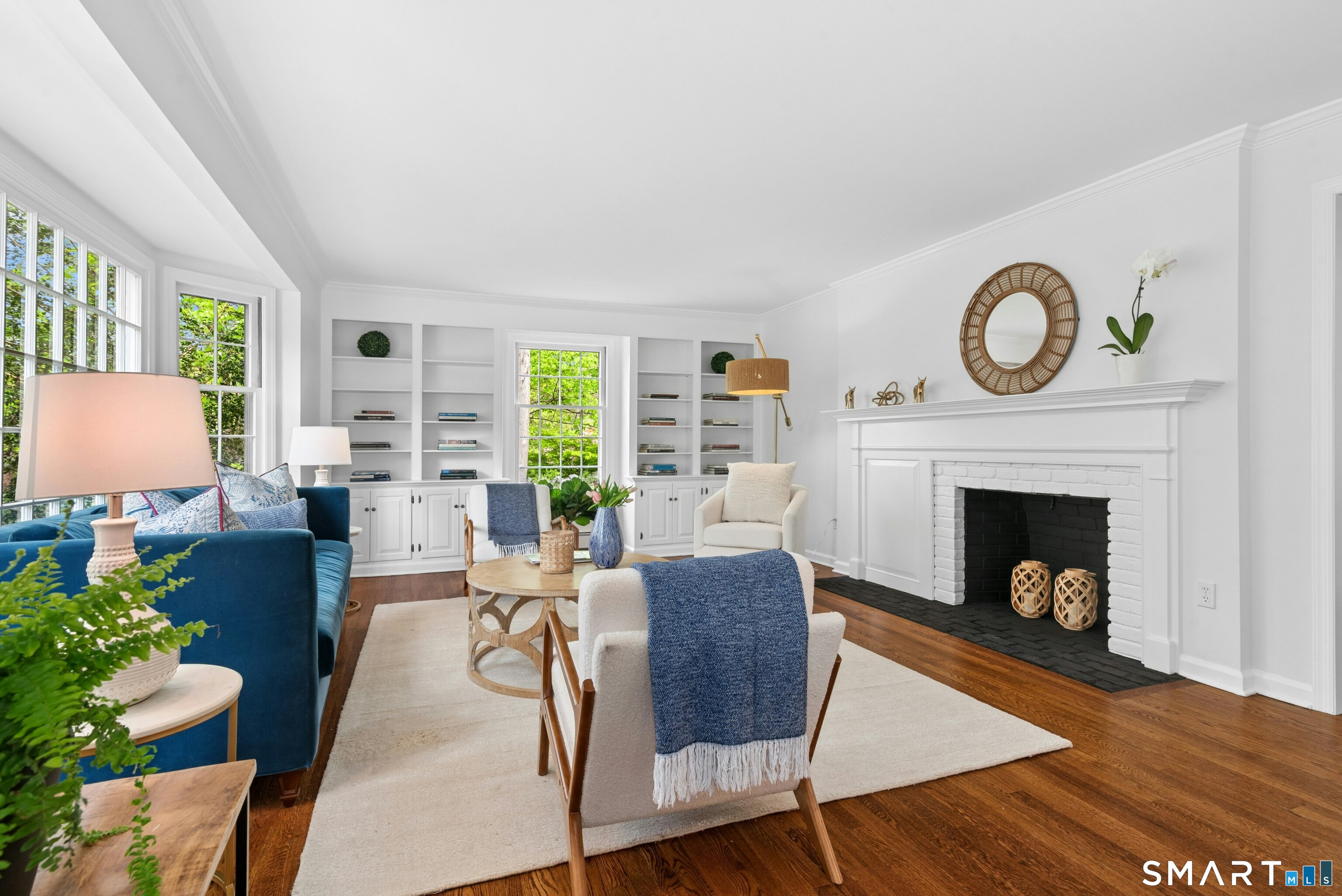 254 White Oak Shade Road New Canaan, CT 06840 - Photo 10 of 31 a living room with furniture a fireplace and a large window