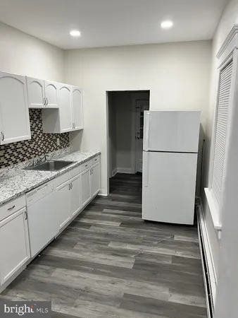 a kitchen with a refrigerator and a stove