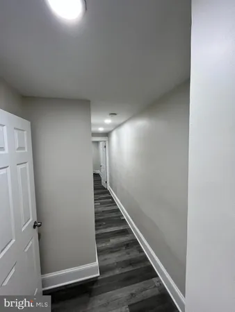 a view of hallway with stairs and wooden floor
