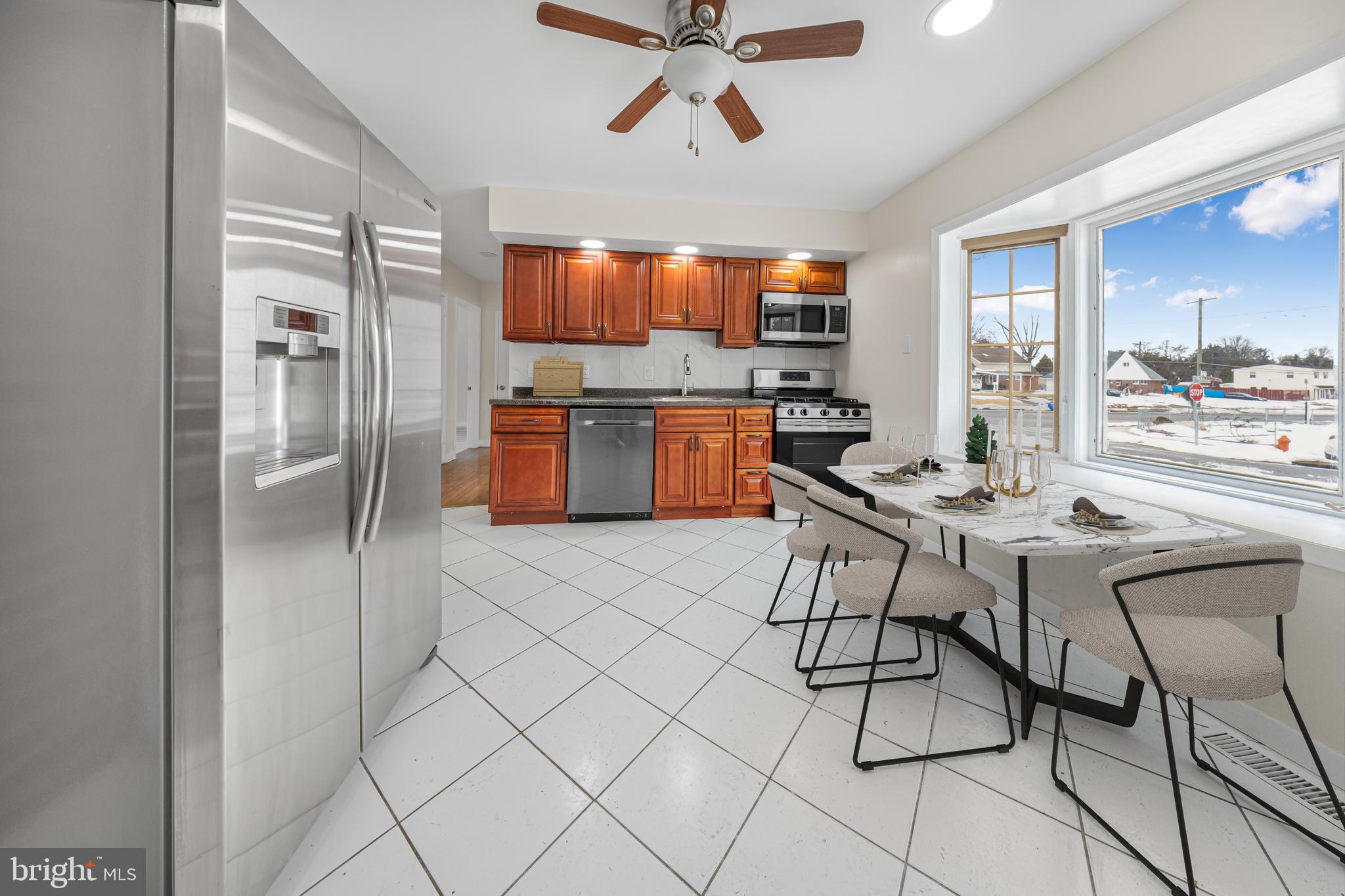 727 Sherrie Road Philadelphia, PA 19115 - Photo 16 of 18 a kitchen with stainless steel appliances kitchen island granite countertop a refrigerator and a stove top oven