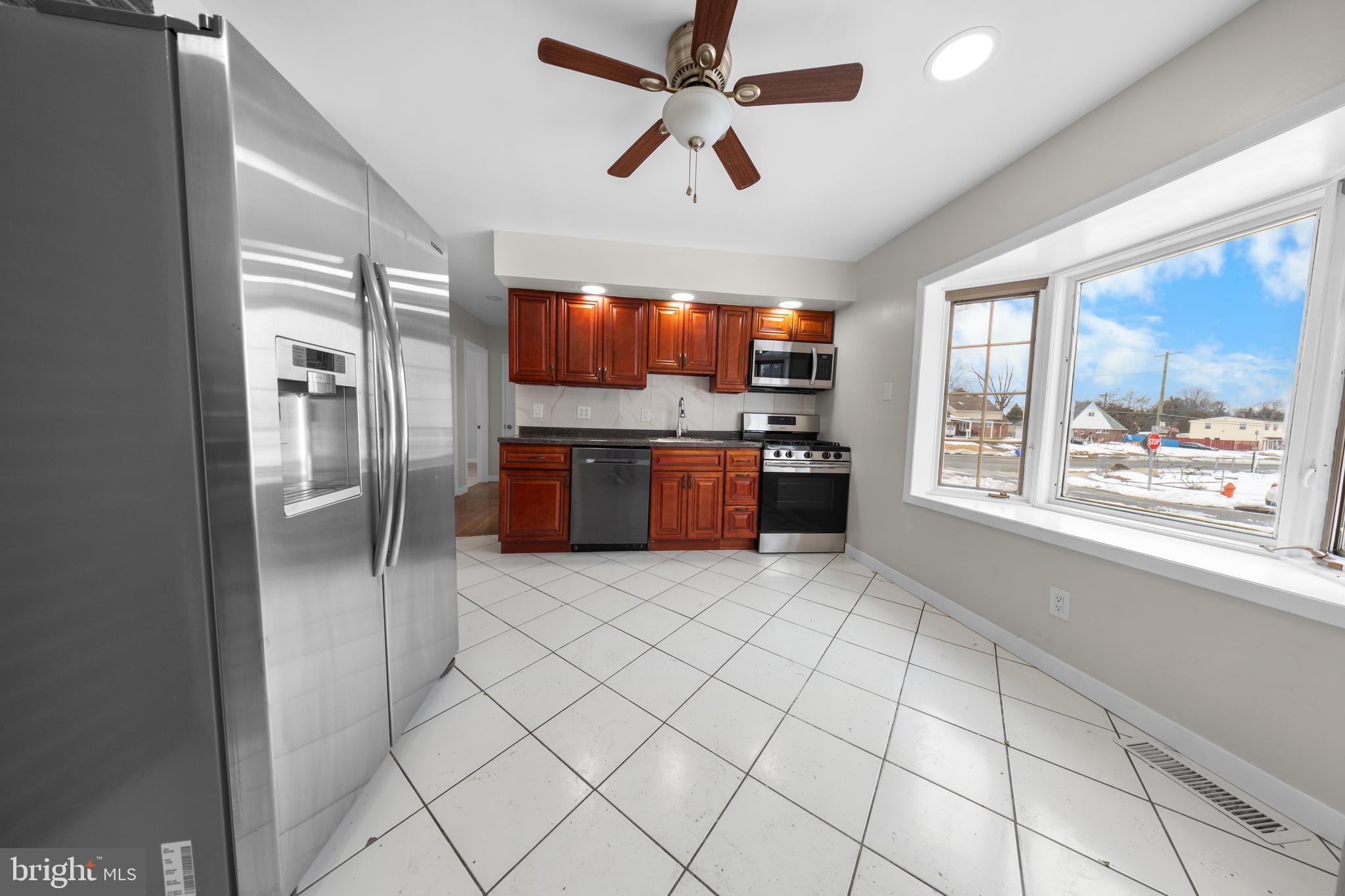 727 Sherrie Road Philadelphia, PA 19115 - Photo 17 of 18 a large kitchen with cabinets and stainless steel appliances