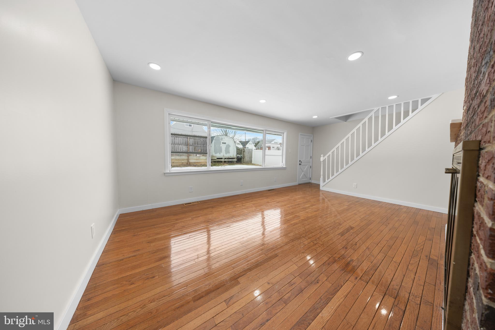 727 Sherrie Road Philadelphia, PA 19115 - Photo 2 of 18 a view of an empty room with wooden floor and a window