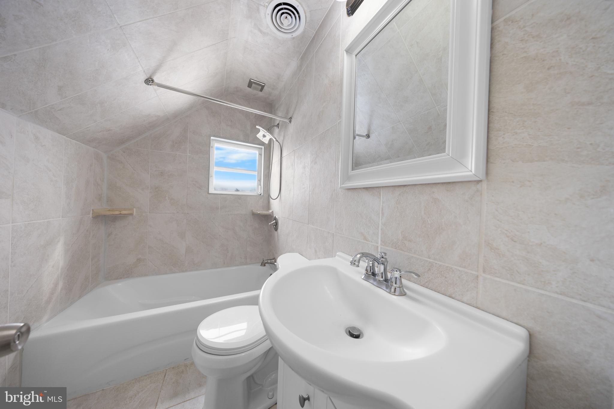 727 Sherrie Road Philadelphia, PA 19115 - Photo 6 of 18 a white bath tub sitting next to a white sink and a toilet
