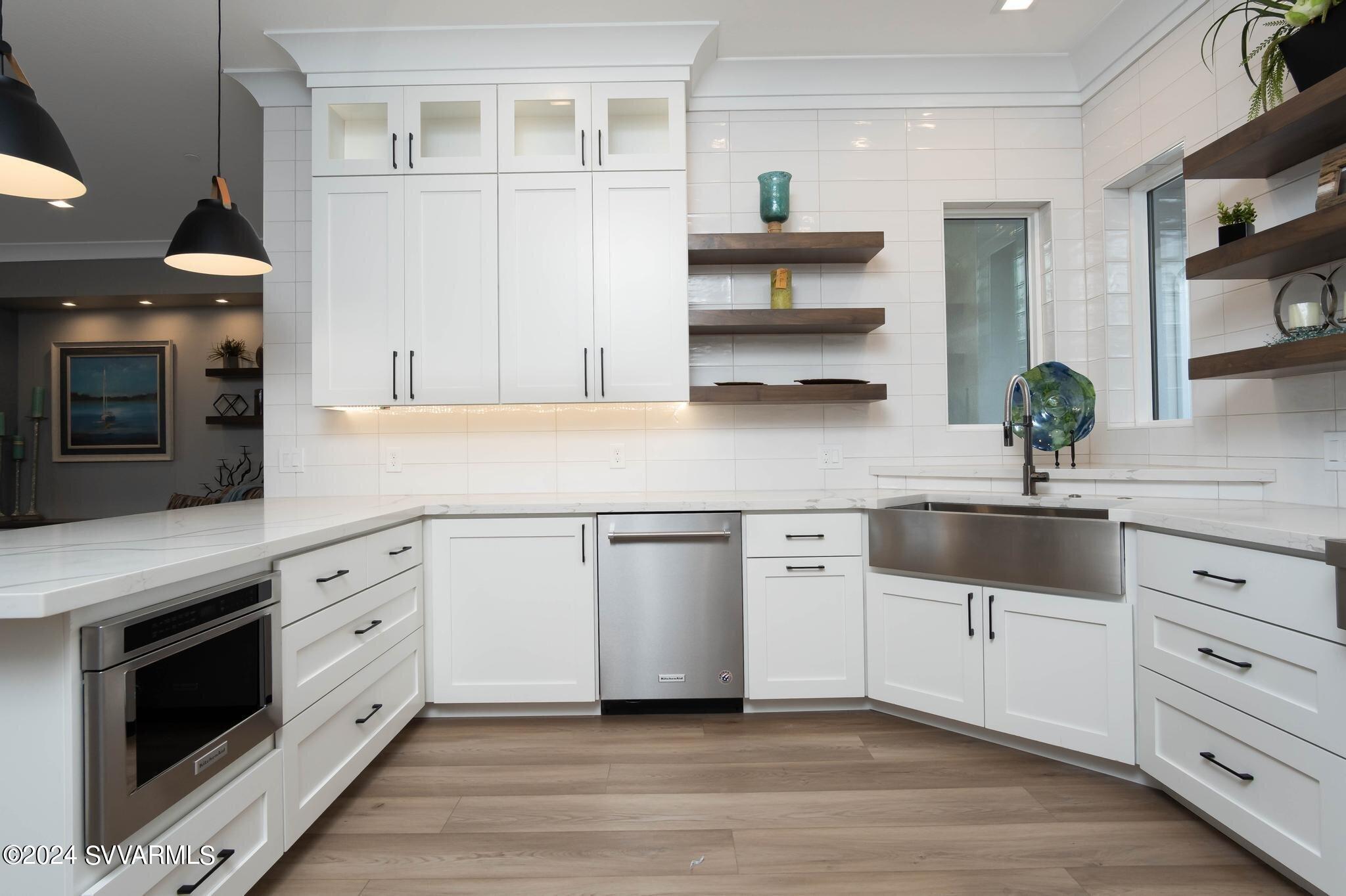699 Moore Gulch Road, Unit LOT 117 Clarkdale, AZ 86324 - Photo 22 of 81 a kitchen with white cabinets stainless steel appliances and a potted plant