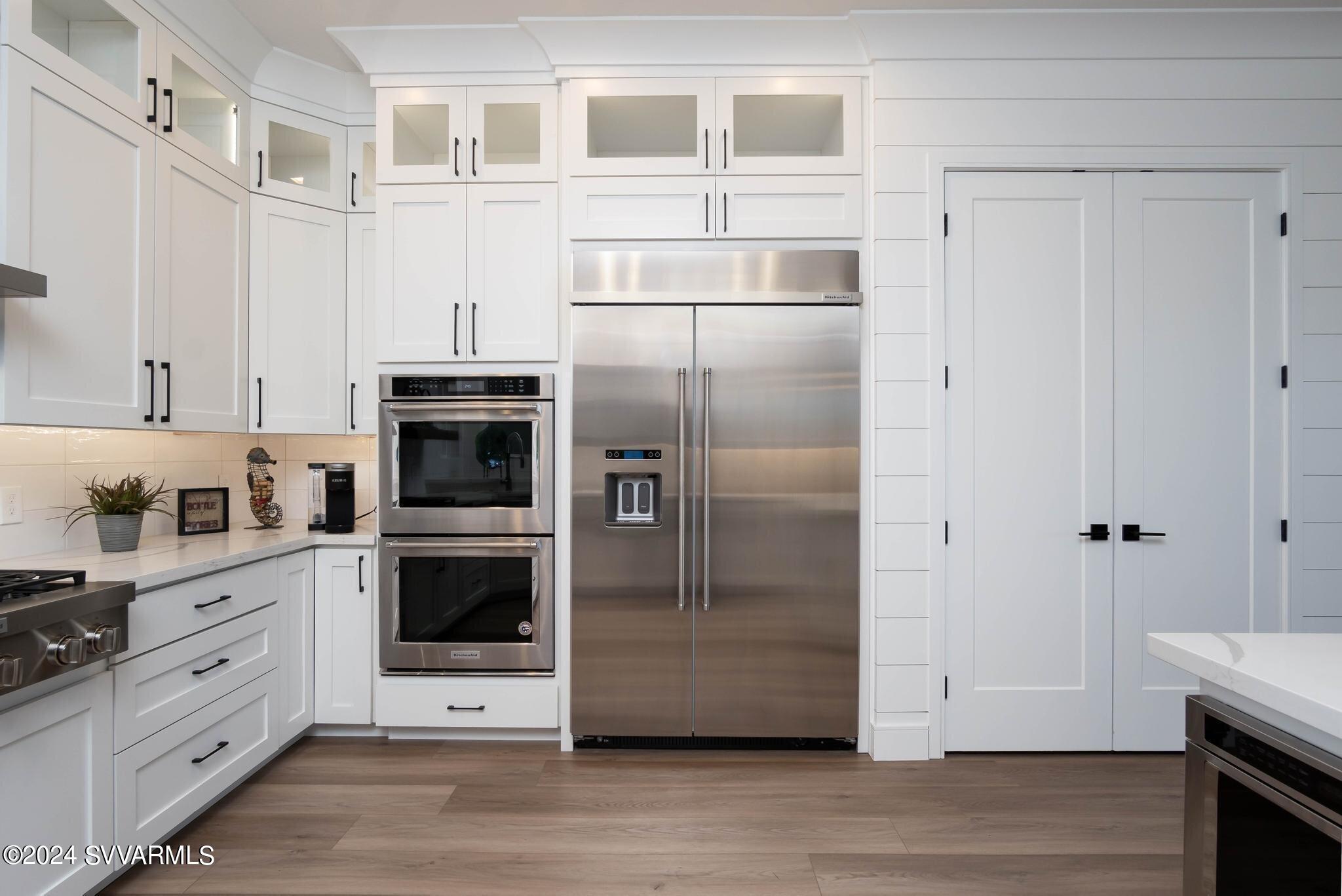 699 Moore Gulch Road, Unit LOT 117 Clarkdale, AZ 86324 - Photo 23 of 81 a kitchen with stainless steel appliances a refrigerator sink and cabinets