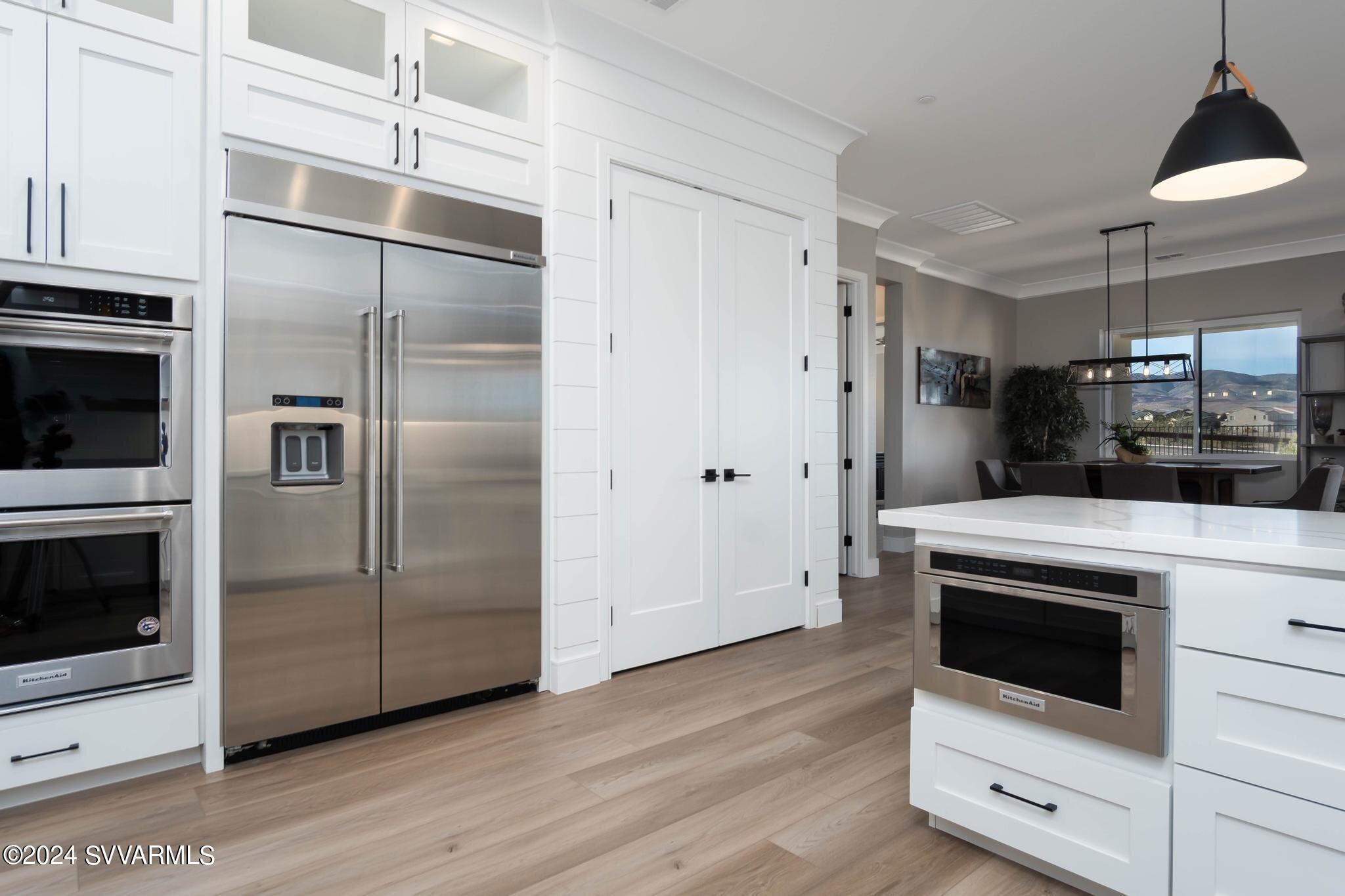 699 Moore Gulch Road, Unit LOT 117 Clarkdale, AZ 86324 - Photo 24 of 81 a kitchen with stainless steel appliances a refrigerator a stove and microwave