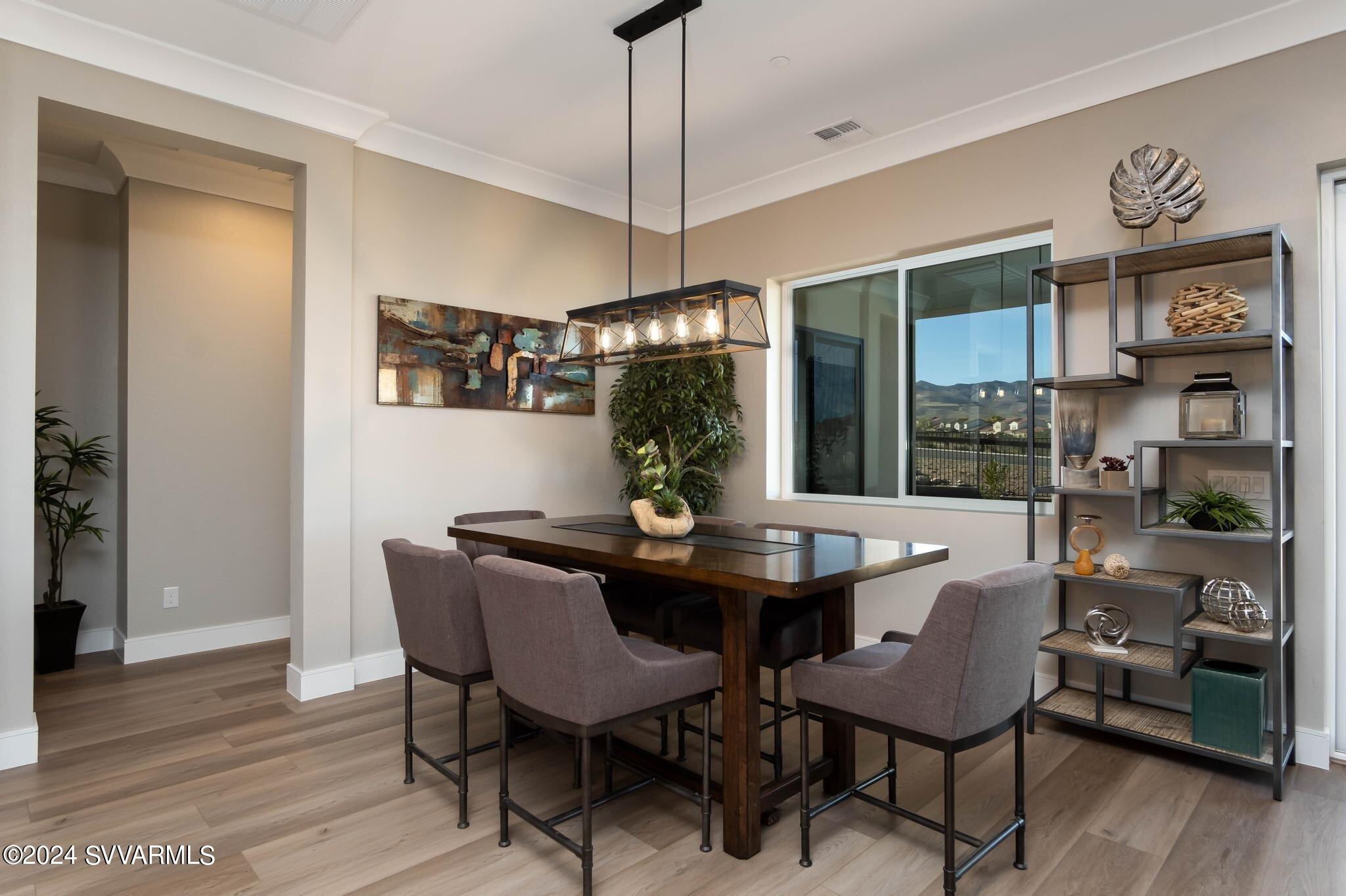 699 Moore Gulch Road, Unit LOT 117 Clarkdale, AZ 86324 - Photo 28 of 81 a view of a dining room with furniture wooden floor and chandelier